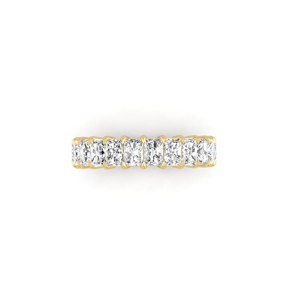 The Half Lab Grown Diamond Eternity Ring from Janet Heller Fine Jewelry, crafted in 18KT gold, features a row of evenly spaced diamonds offered in various shapes and custom carat weights. The color of the diamonds is F and the clarity is VS. This is the perfect wedding band to be worn alone or stacked with your engagement ring.