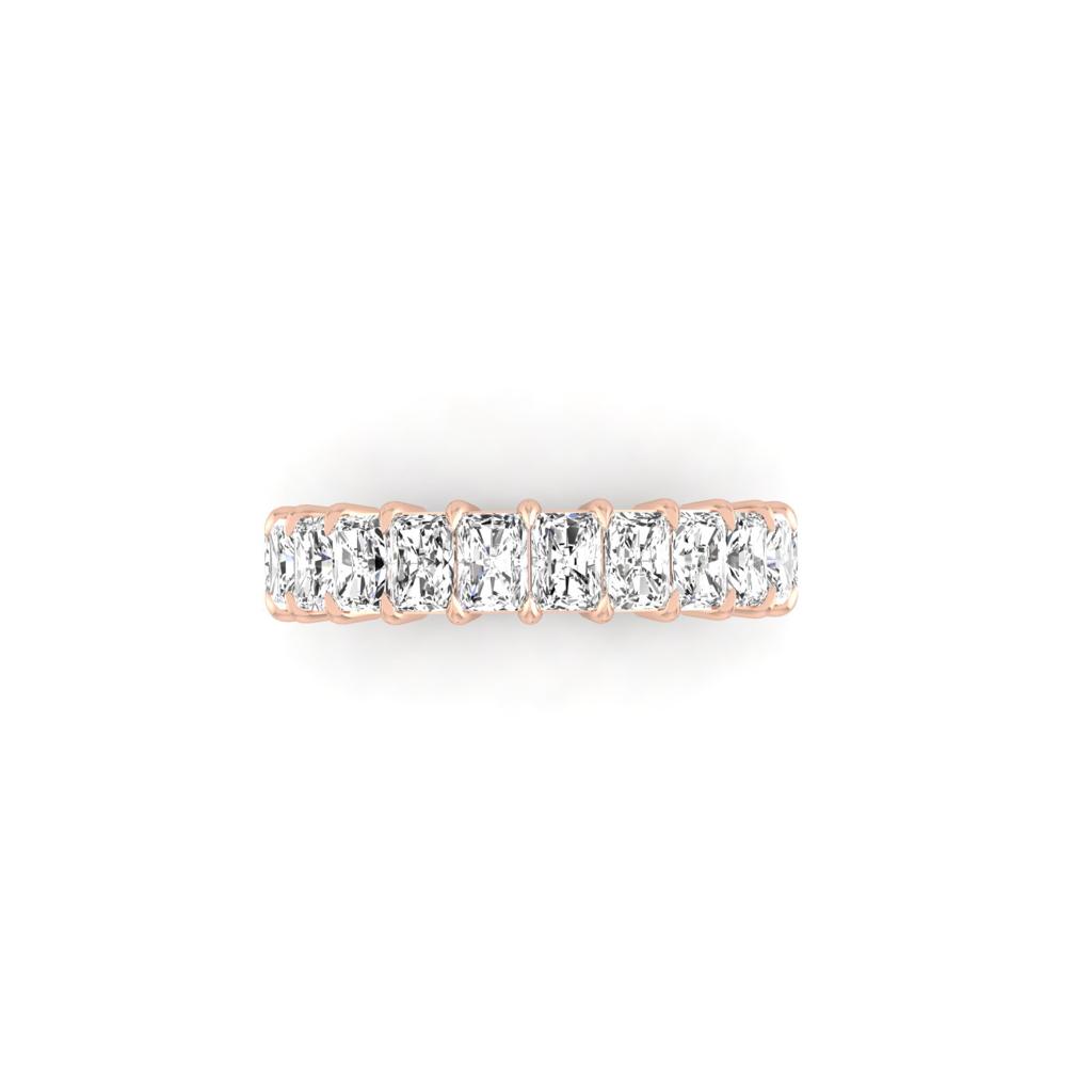 The Half Lab Grown Diamond Eternity Ring from Janet Heller Fine Jewelry, crafted in 18KT gold, features a row of evenly spaced diamonds offered in various shapes and custom carat weights. The color of the diamonds is F and the clarity is VS. This is the perfect wedding band to be worn alone or stacked with your engagement ring.