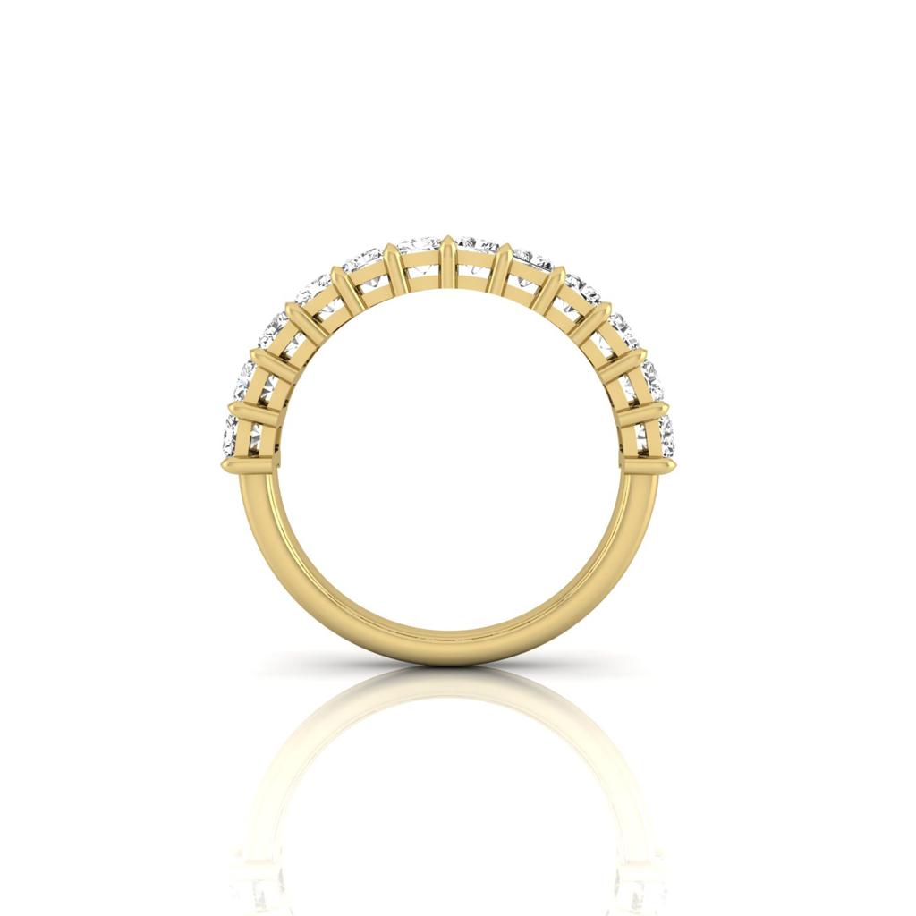 The Half Lab Grown Diamond Eternity Ring from Janet Heller Fine Jewelry, crafted in 18KT gold, features a row of evenly spaced diamonds offered in various shapes and custom carat weights. The color of the diamonds is F and the clarity is VS. This is the perfect wedding band to be worn alone or stacked with your engagement ring.
