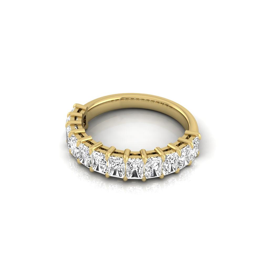 The Half Lab Grown Diamond Eternity Ring from Janet Heller Fine Jewelry, crafted in 18KT gold, features a row of evenly spaced diamonds offered in various shapes and custom carat weights. The color of the diamonds is F and the clarity is VS. This is the perfect wedding band to be worn alone or stacked with your engagement ring.