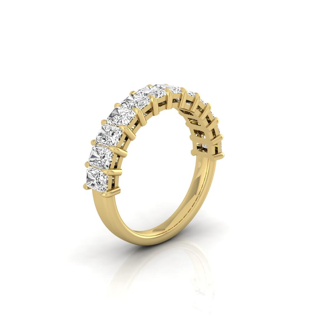 The Half Lab Grown Diamond Eternity Ring from Janet Heller Fine Jewelry, crafted in 18KT gold, features a row of evenly spaced diamonds offered in various shapes and custom carat weights. The color of the diamonds is F and the clarity is VS. This is the perfect wedding band to be worn alone or stacked with your engagement ring.