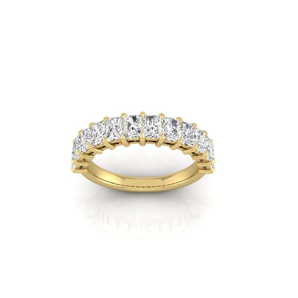 The Half Lab Grown Diamond Eternity Ring from Janet Heller Fine Jewelry, crafted in 18KT gold, features a row of evenly spaced diamonds offered in various shapes and custom carat weights. The color of the diamonds is F and the clarity is VS. This is the perfect wedding band to be worn alone or stacked with your engagement ring.