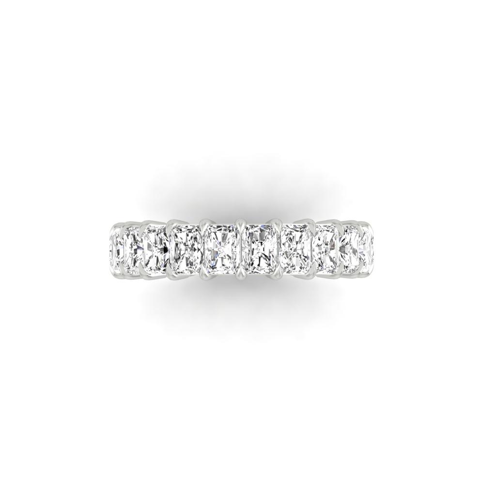 The Full Lab Grown Diamond Eternity Ring displays a row of sparkling rectangular diamonds set closely together. Featuring F Color VS Clarity stones, this silver piece reflects elegance and meticulous craftsmanship on a white background.