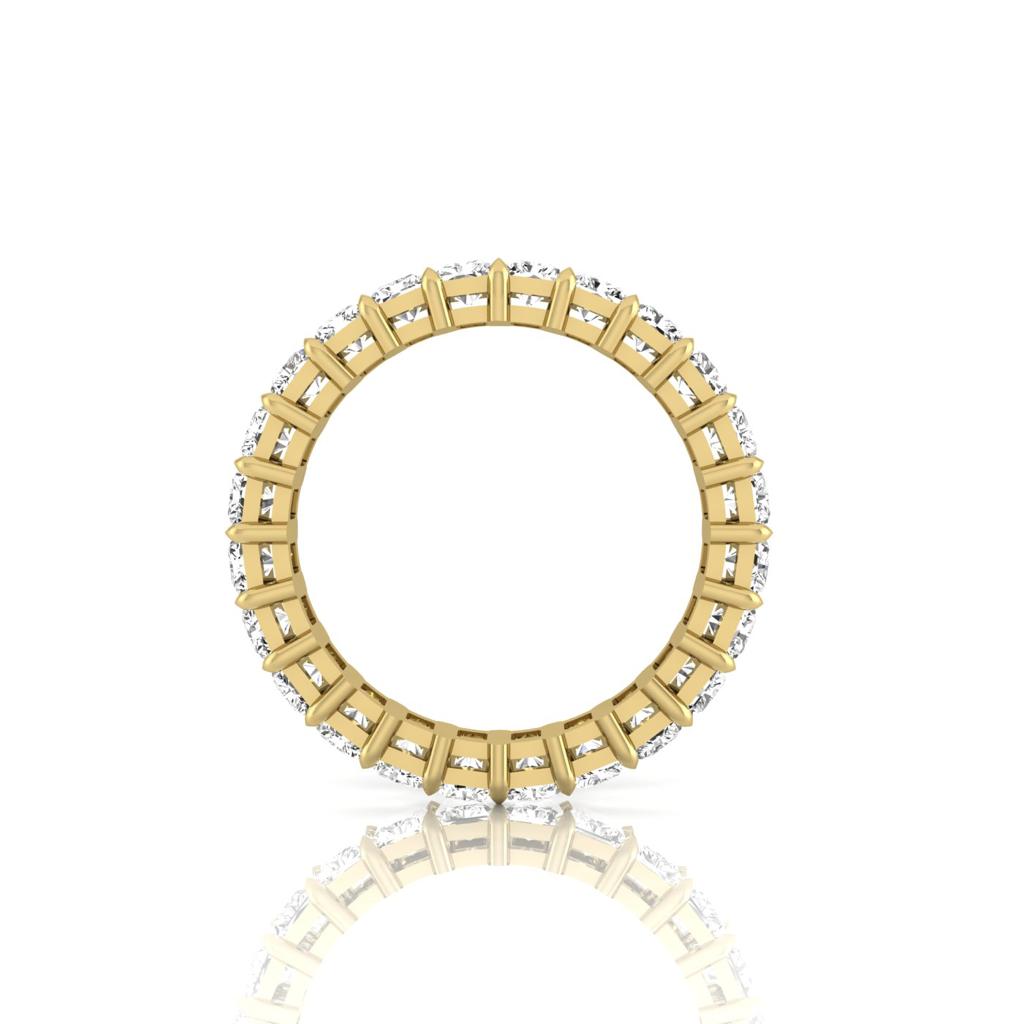Side view of the Full Lab Grown Diamond Eternity Ring, fashioned in 18KT gold with F color VS clarity diamonds encircling it, elegantly reflecting on a white surface.