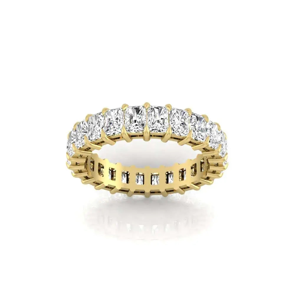 The Full Diamond Eternity Ring is crafted from 18KT gold, featuring square-cut F Color diamonds in a continuous prong setting. With VS Clarity, the polished band enhances the brilliance of these stunning gemstones.