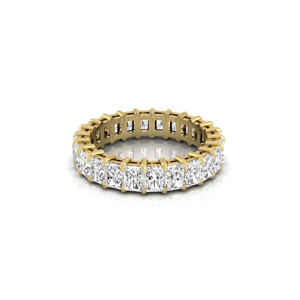 The Full Lab Grown Diamond Eternity Ring is crafted in 18KT gold and features a continuous row of closely set, square-cut diamonds with F color and VS clarity that encircle the band, elegantly displayed against a plain white background.
