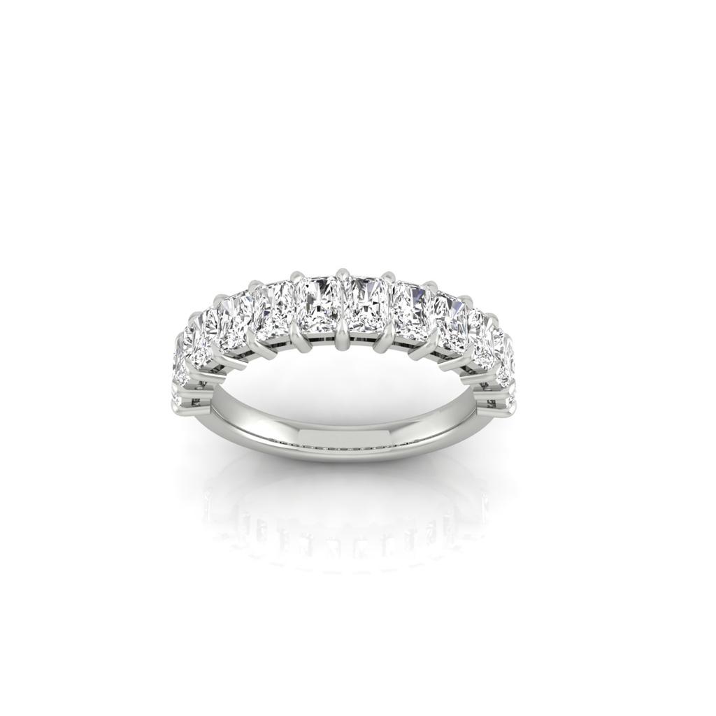 The Half Lab Grown Diamond Eternity Ring from Janet Heller Fine Jewelry, crafted in 18KT gold, features a row of evenly spaced diamonds offered in various shapes and custom carat weights. The color of the diamonds is F and the clarity is VS. This is the perfect wedding band to be worn alone or stacked with your engagement ring.