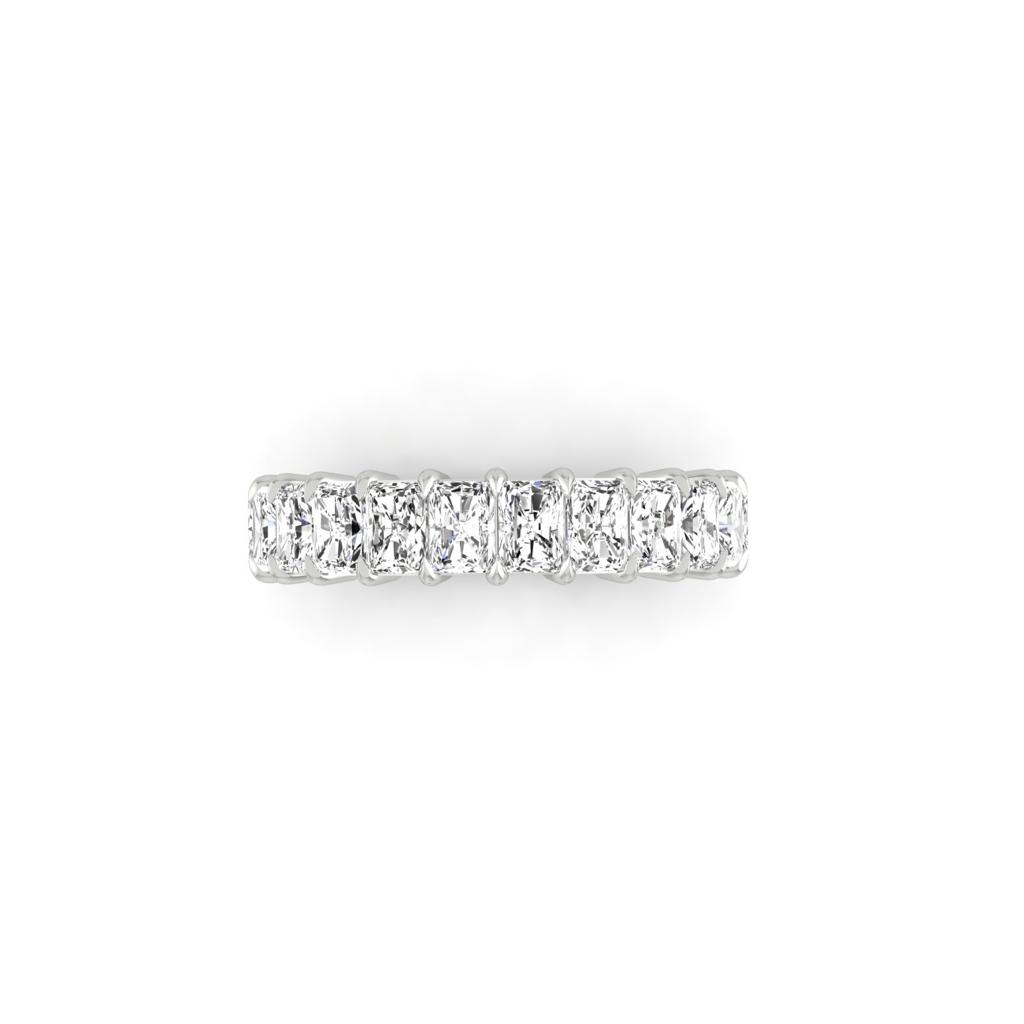 The Half Diamond Eternity Ring, featuring a row of sparkling VS Clarity diamonds set against a plain white silver background, exudes elegance and precision.