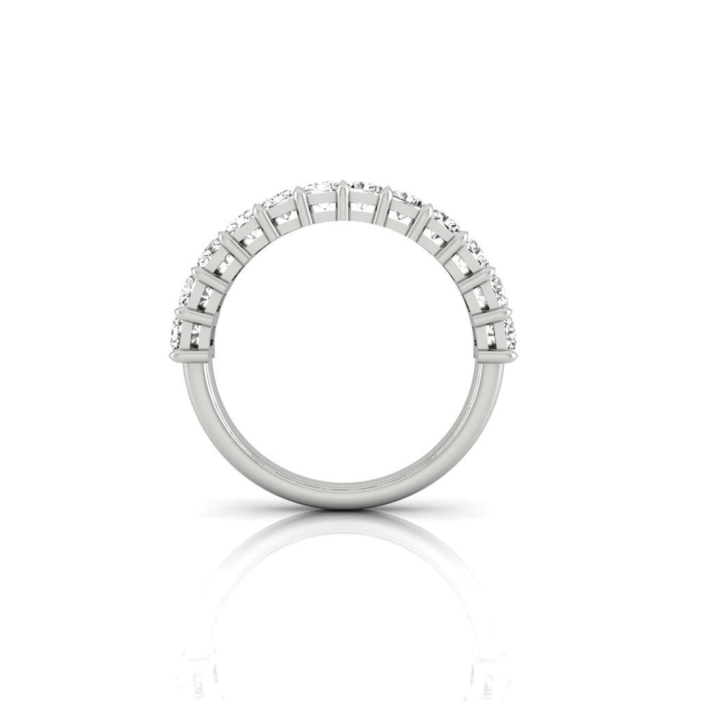 The Half Lab Grown Diamond Eternity Ring from Janet Heller Fine Jewelry, crafted in 18KT gold, features a row of evenly spaced diamonds offered in various shapes and custom carat weights. The color of the diamonds is F and the clarity is VS. This is the perfect wedding band to be worn alone or stacked with your engagement ring.