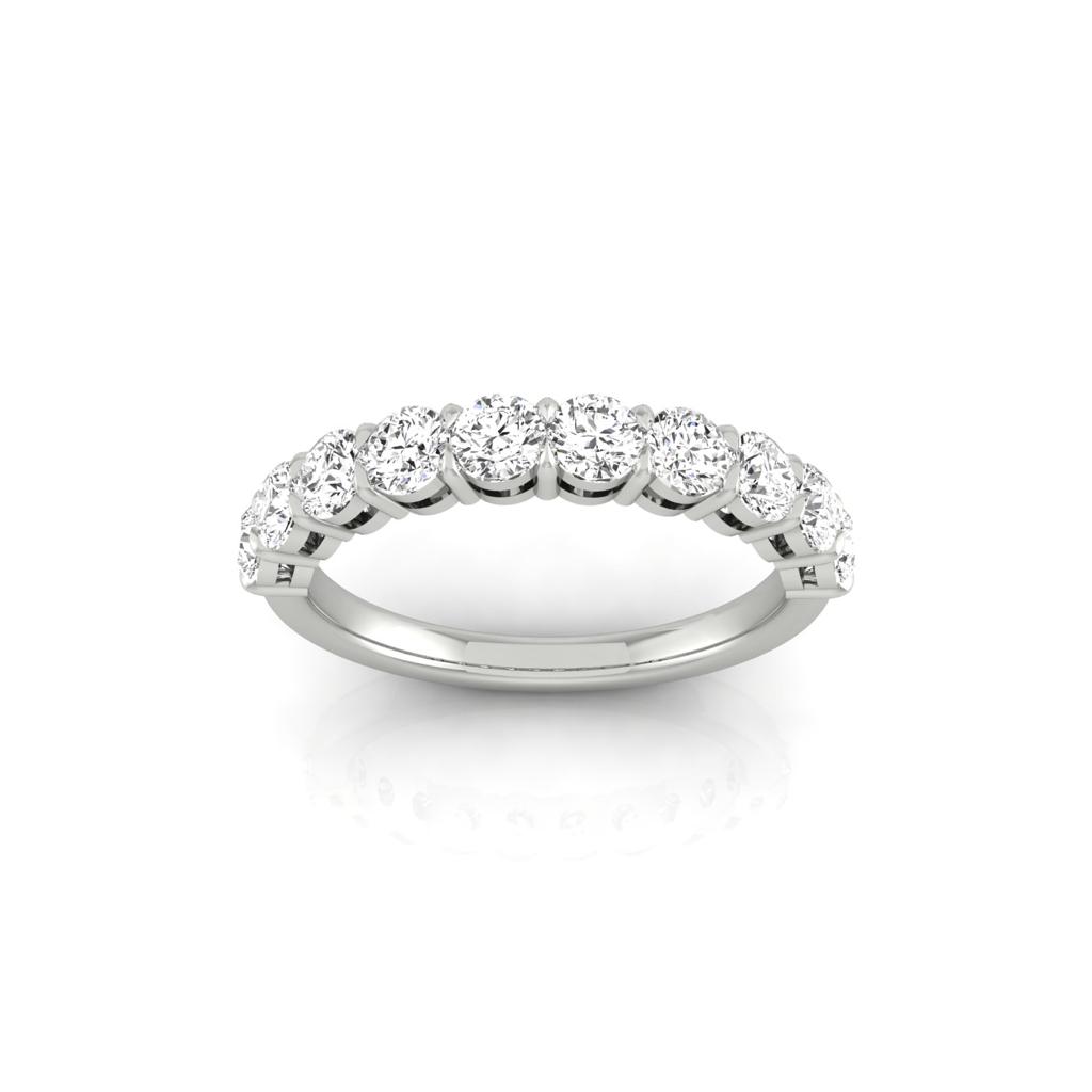 The Half Diamond Eternity Ring features 18KT gold with a prong-set row of round, sparkling diamonds. It is showcased against a plain white background to highlight its custom carat weights and elegance.