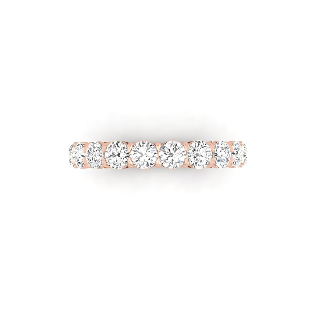 The Half Lab Grown Diamond Eternity Ring from Janet Heller Fine Jewelry, crafted in 18KT gold, features a row of evenly spaced diamonds offered in various shapes and custom carat weights. The color of the diamonds is F and the clarity is VS. This is the perfect wedding band to be worn alone or stacked with your engagement ring.