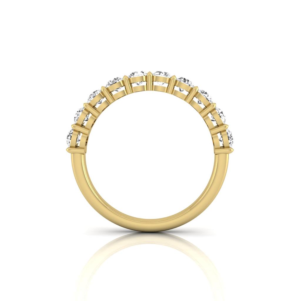 The side view of the Half Diamond Eternity Ring features 18KT gold with round-cut diamonds set in prongs along the top half. Photographed on a white background, it casts a subtle reflection below.