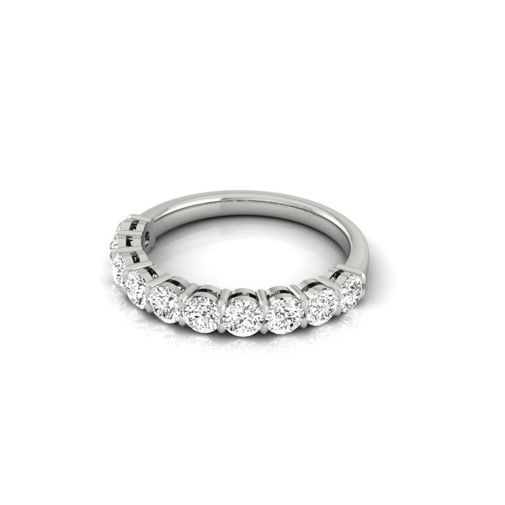 The Half Lab Grown Diamond Eternity Ring from Janet Heller Fine Jewelry, crafted in 18KT gold, features a row of evenly spaced diamonds offered in various shapes and custom carat weights. The color of the diamonds is F and the clarity is VS. This is the perfect wedding band to be worn alone or stacked with your engagement ring.