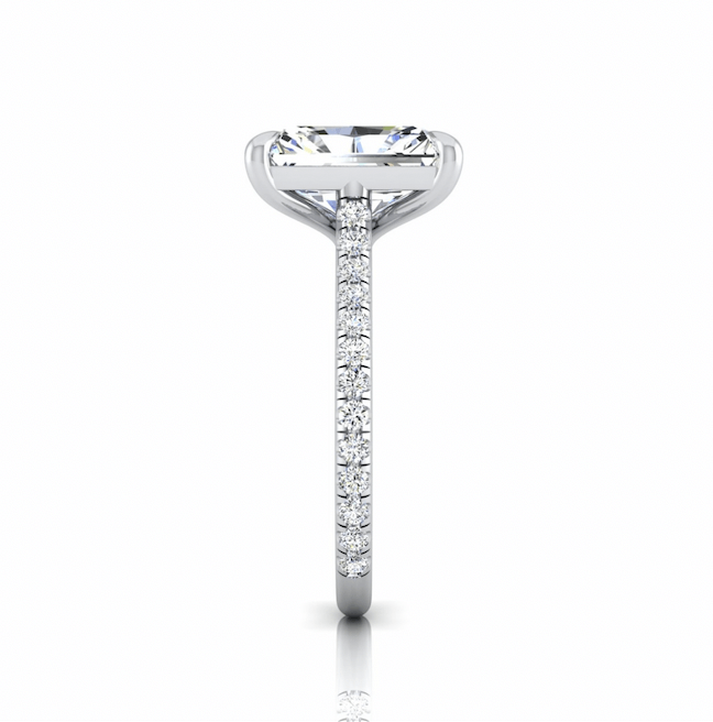 Side view of the Unity solitaire engagement ring showcases a large rectangular center diamond in an elegant U Prong set, with a white gold band adorned by a pavé diamond band. Its reflection is visible below, adding sparkle and elegance to the design.