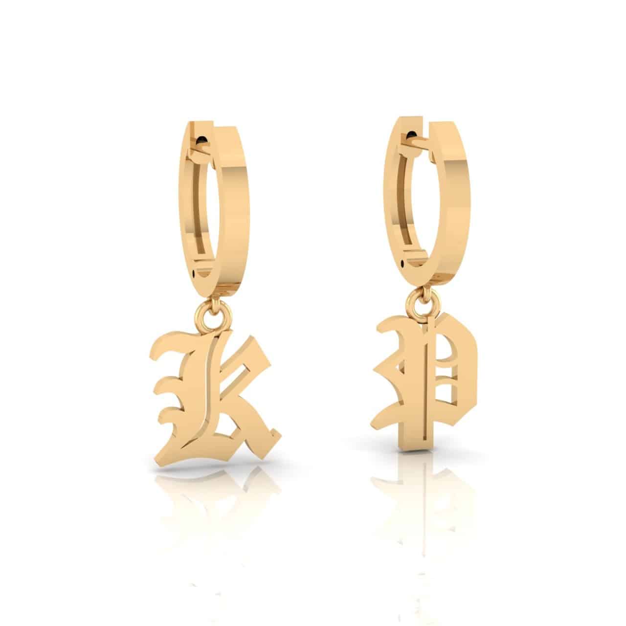 The Small Old English Initial Huggies are gold hoop earrings with Gothic-style K and P charms. They have a shiny finish, making them unique jewelry pieces that stand out against a plain background.