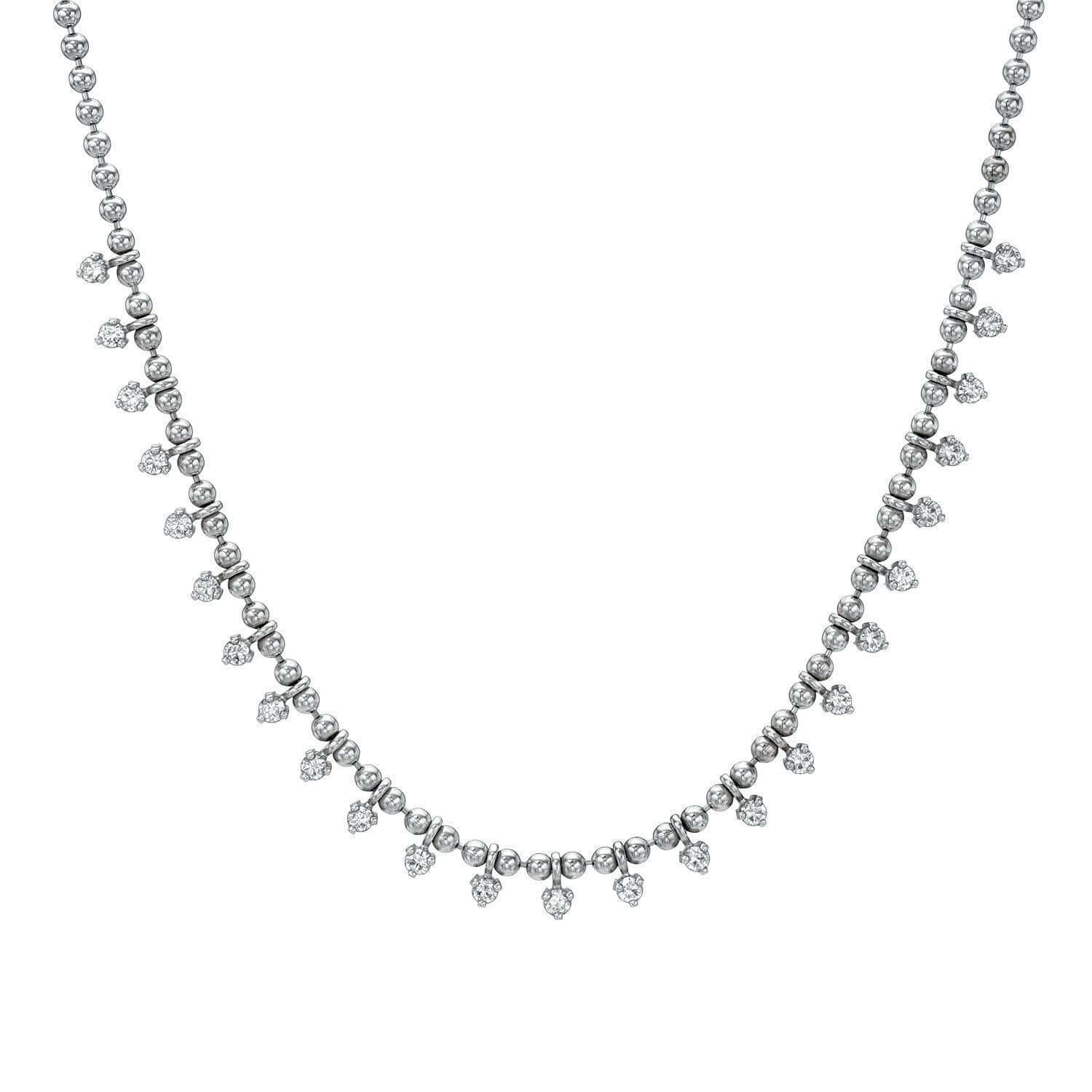 The 14KW Diamond Gisele Necklace by Janet Heller Fine Jewelry features evenly spaced round beads and dangling pear-shaped diamonds on an adjustable chain.  The necklace can be worn on its own or layered with other necklaces.