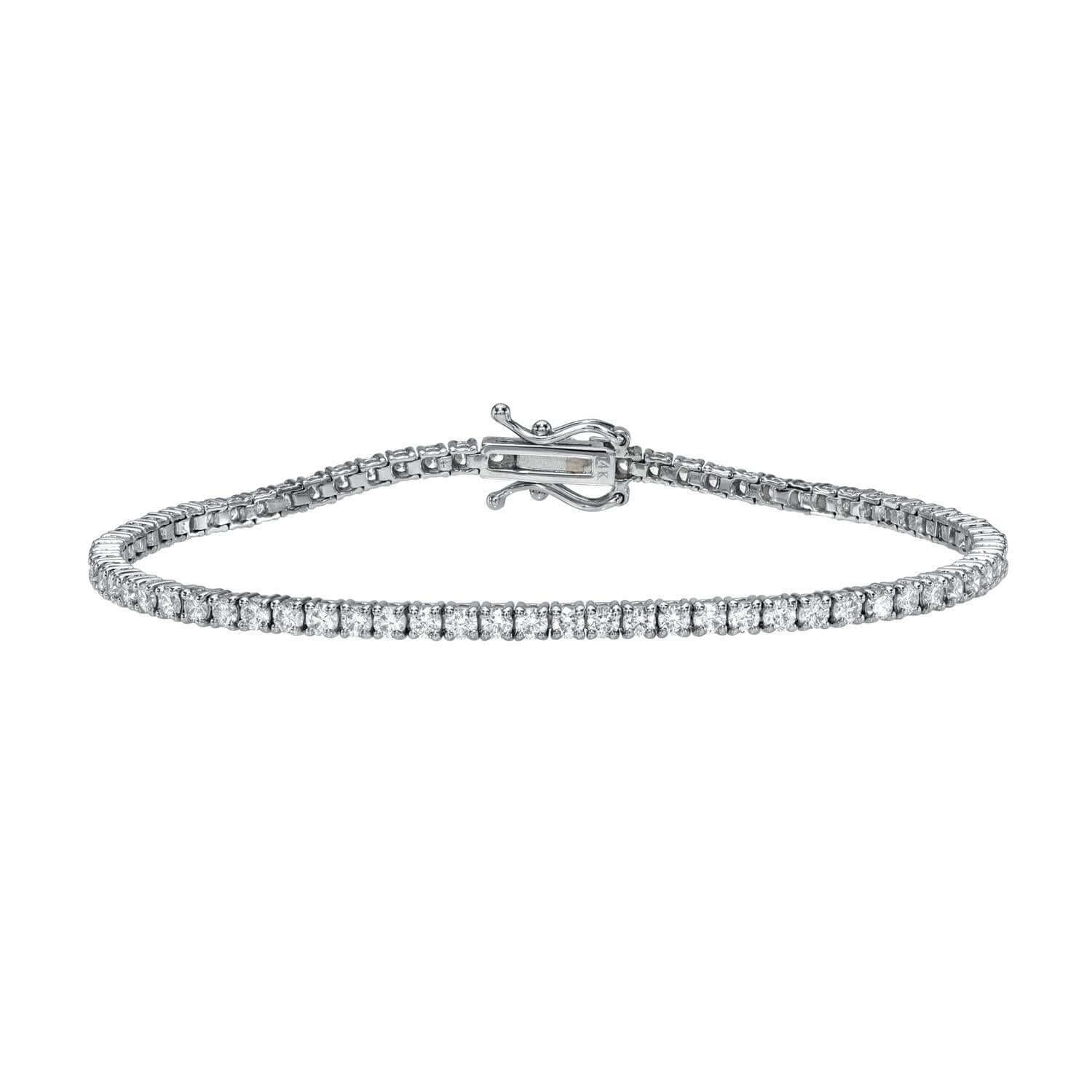 The 2ct Round Diamond Tennis Bracelet is a silver piece featuring a line of small, sparkling lab-grown diamonds. Its elegant clasp and polished design embody the simplicity and sophistication of fine jewelry.
