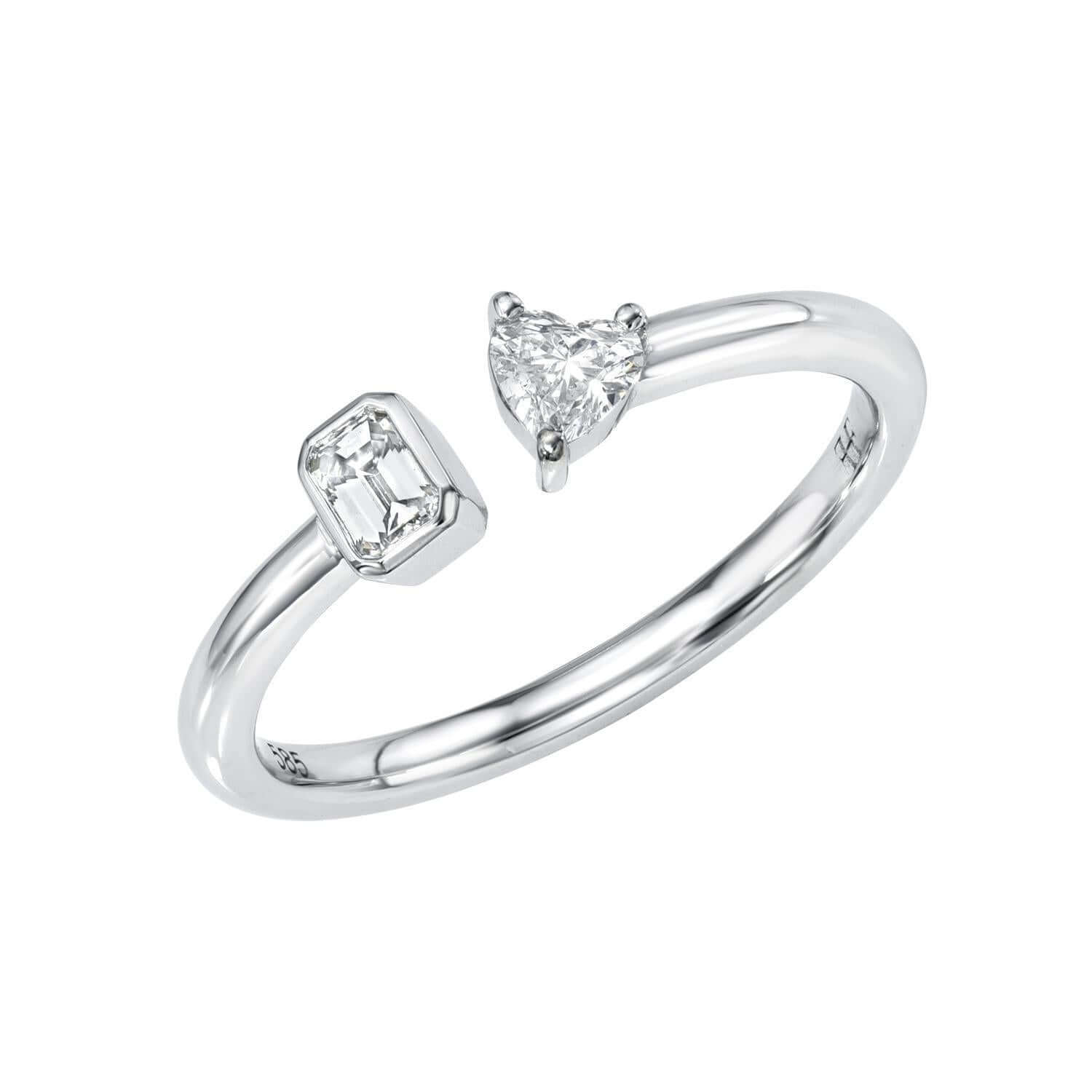 The Emerald & Heart Toi Et Moi Ring is a minimalist design with two distinct diamonds: a rectangular emerald-cut on one side and a triangular pear-shaped on the other. Its sleek silver band symbolizes partnerships, offering an elegant and modern aesthetic.