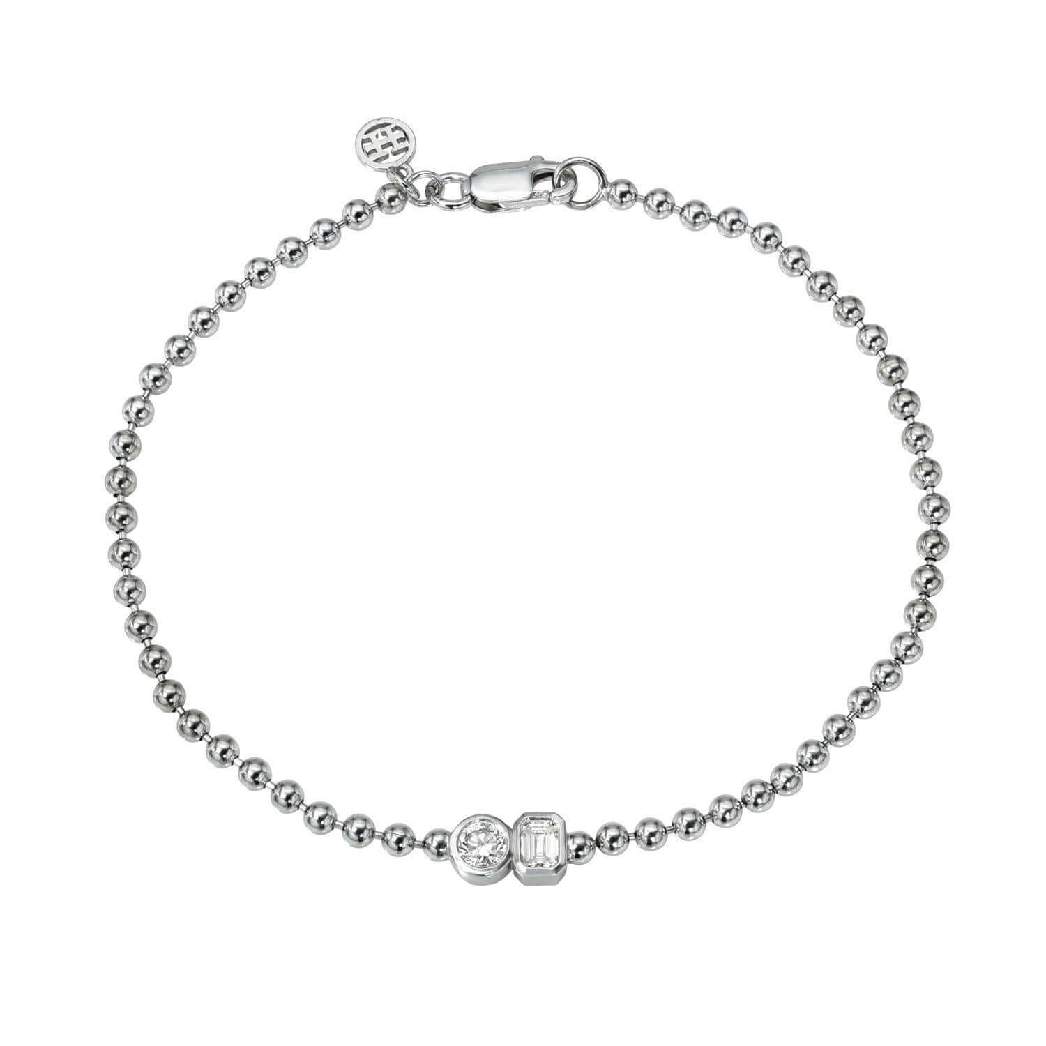 The Emerald & Round Toi Et Moi Bracelet is a delicate silver piece featuring round beads, two crystal accents (one round, one rectangular), and an intricately detailed charm near the circular clasp—ideal for celebrating love stories with elegance.