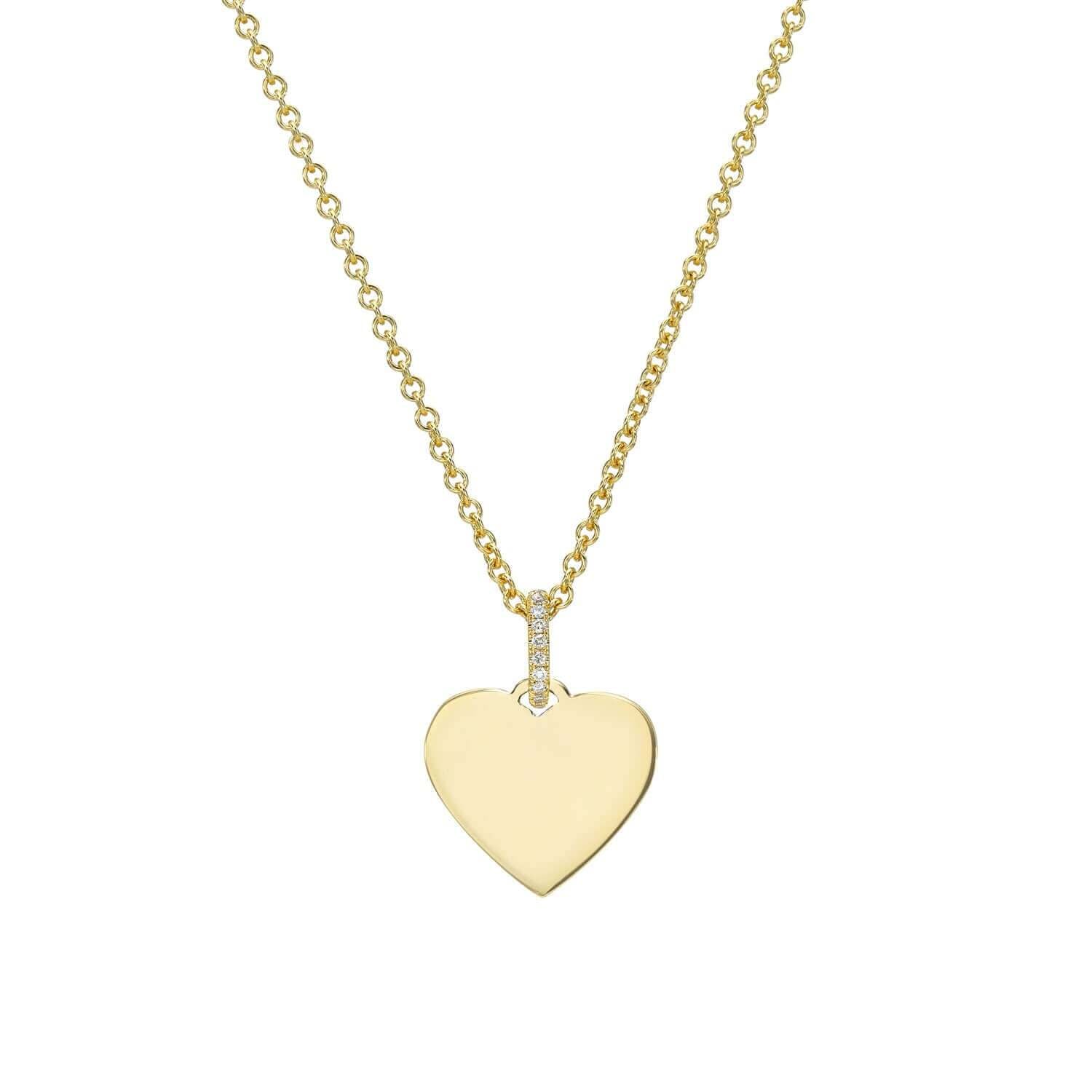Part of the Sketch Collection, the Mini Heart Engravable Pendant Necklace from Janet Heller Fine Jewelry is crafted in 14KT gold. The necklace features a delicate chain with a diamond-studded loop and a heart-shaped charm perfect for engraving a personalized message.