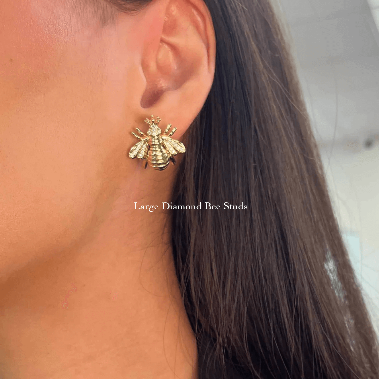 The Diamond Bee Studs from Janet Heller Fine Jewelry are crafted in 14KT gold. The studs feature gold bees adorned with diamonds. The earrings can be worn on their own or layered along the ear with other earrings.