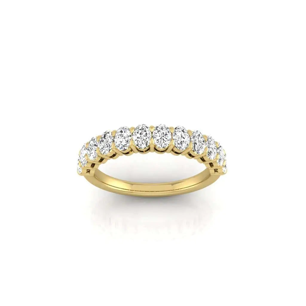 This elegant Half Diamond Eternity Ring, crafted in 18KT gold, features a row of sparkling oval diamonds in a prong setting with VS clarity. Centered against a plain white background, its exquisite design shines beautifully.
