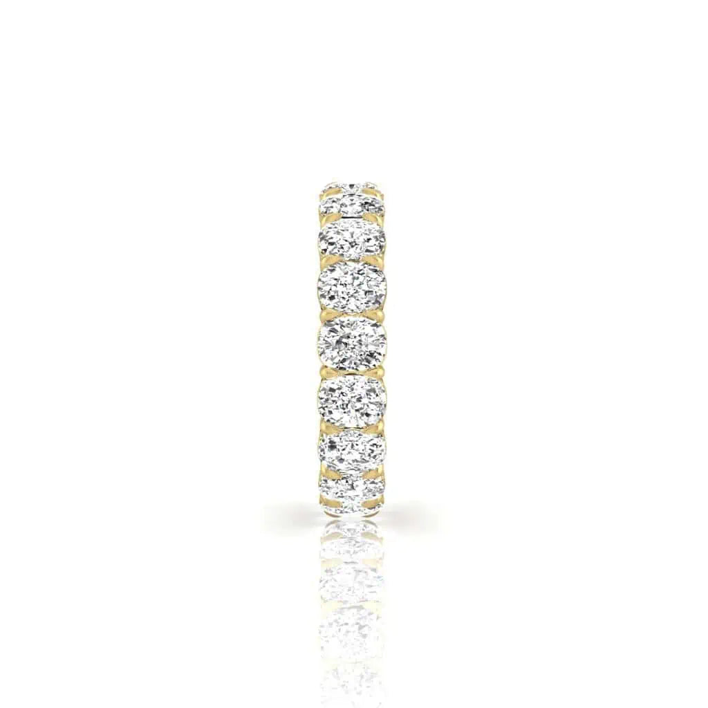 The Full Diamond Eternity Ring in 18KT gold showcases a continuous row of round-cut diamonds with F color and VS clarity against a white background, accentuated by its seamless design and reflection.