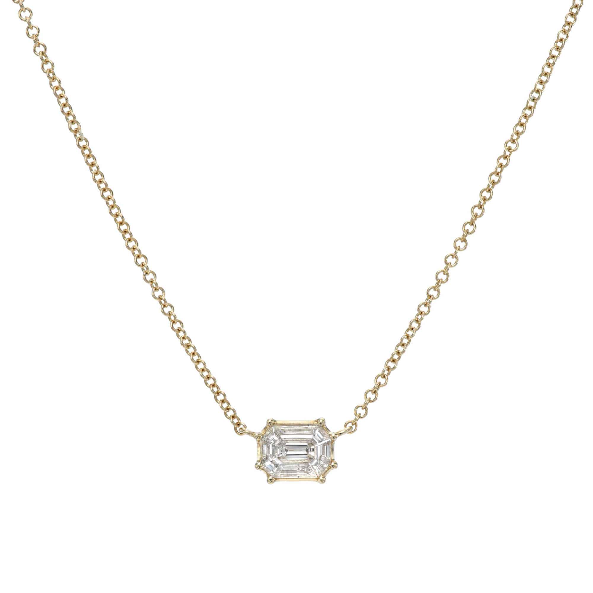 The Emerald Cut Solitaire Mae Necklace from Janet Heller Fine Jewlery is crafted in 14KT gold.  The dainty necklace features a rectangular emerald-cut diamond pendant. The necklace can be worn alone or layered with other chains.