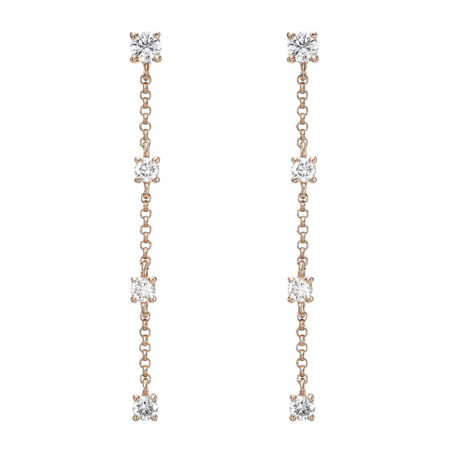 The 4 Drop Diamond Finley Earrings are a stunning fine jewelry piece with small, round, sparkling gems set in gold. These elegant drop earrings feature evenly spaced gems along thin gold chains, exuding delicate sophistication.