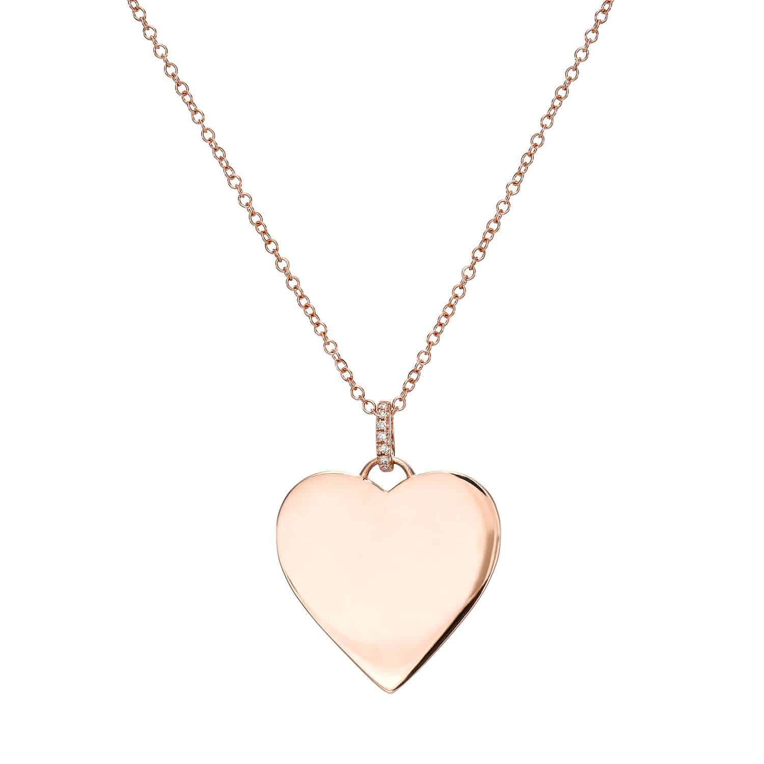 The Brinley Necklace features a shiny, smooth, heart-shaped pendant that hangs elegantly from a gold chain, displayed against a white background—perfect for those looking to personalize their jewelry with an engraving.