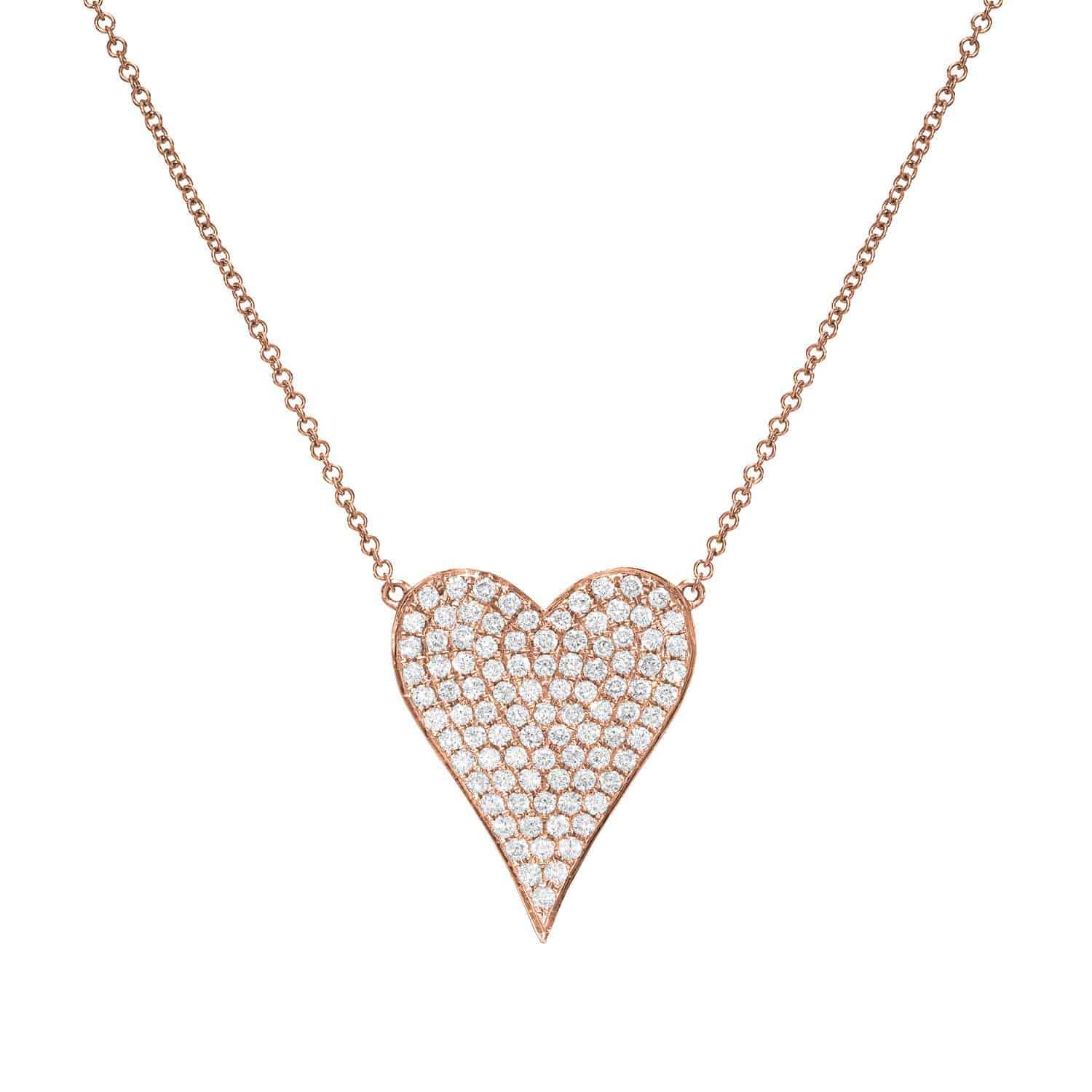 The Diamond Heart Alina Necklace from Janet Heller Fine Jewelry features an elegant heart-shaped pendant adorned with small diamonds on a thin gold chain. Its subtle asymmetrical design offers unique customization options for a stunning effect.