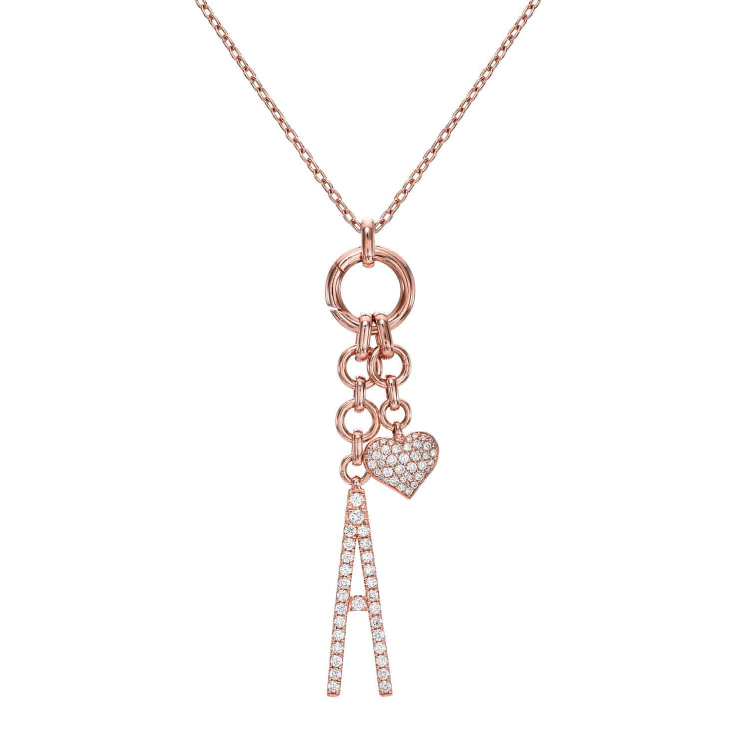 Introducing the Diamond Initial Haven Necklace—a rose gold necklace featuring a pendant with the letter A and a petite heart charm, both adorned with sparkling clear crystals. Dangling from elegant circular links, this personalized letter necklace adds a custom touch to your everyday look. Now available for preorder.