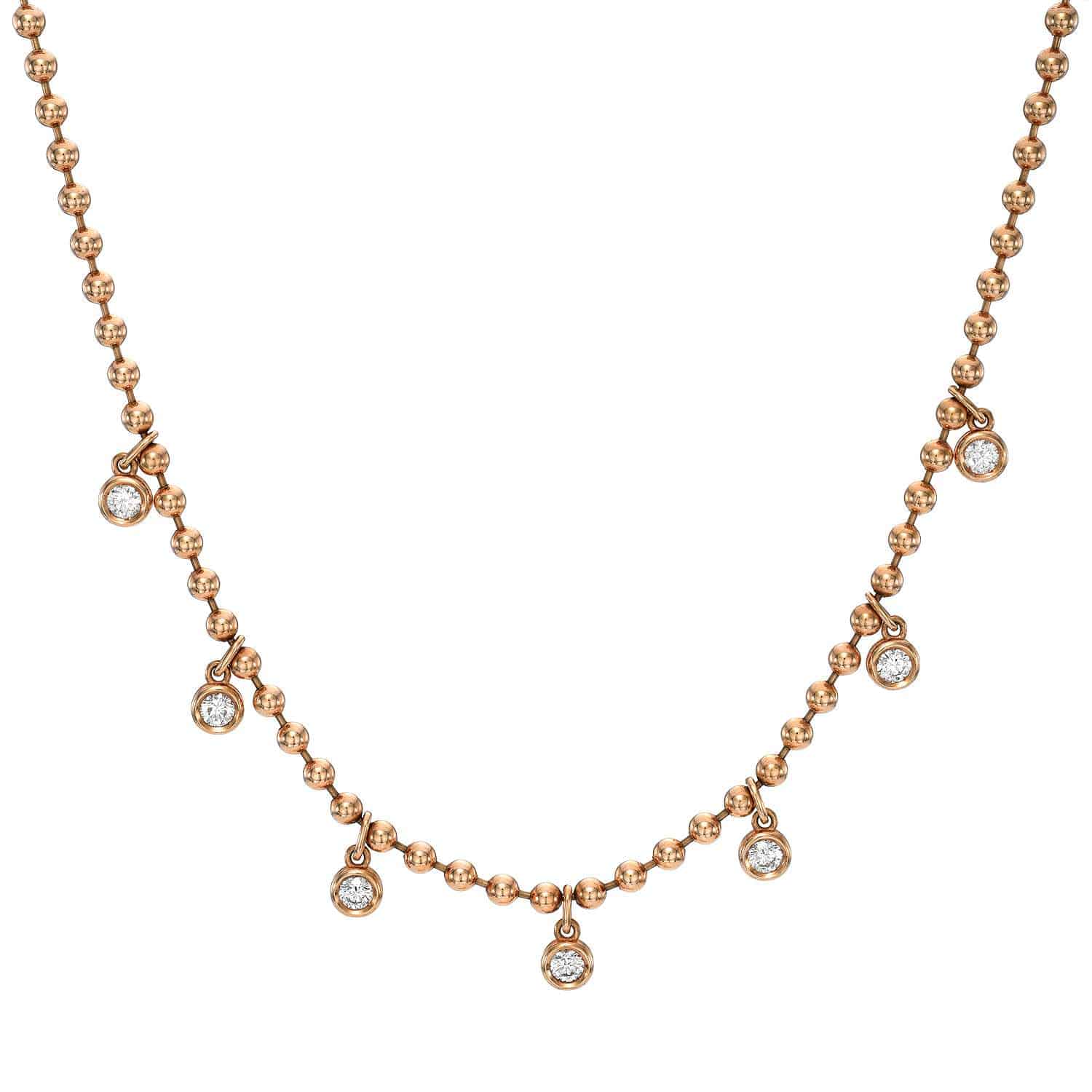 Experience elegance with the Diamond Kinsley Necklace: a gold beaded design adorned with sparkling, diamond-like stones that capture light brilliantly.