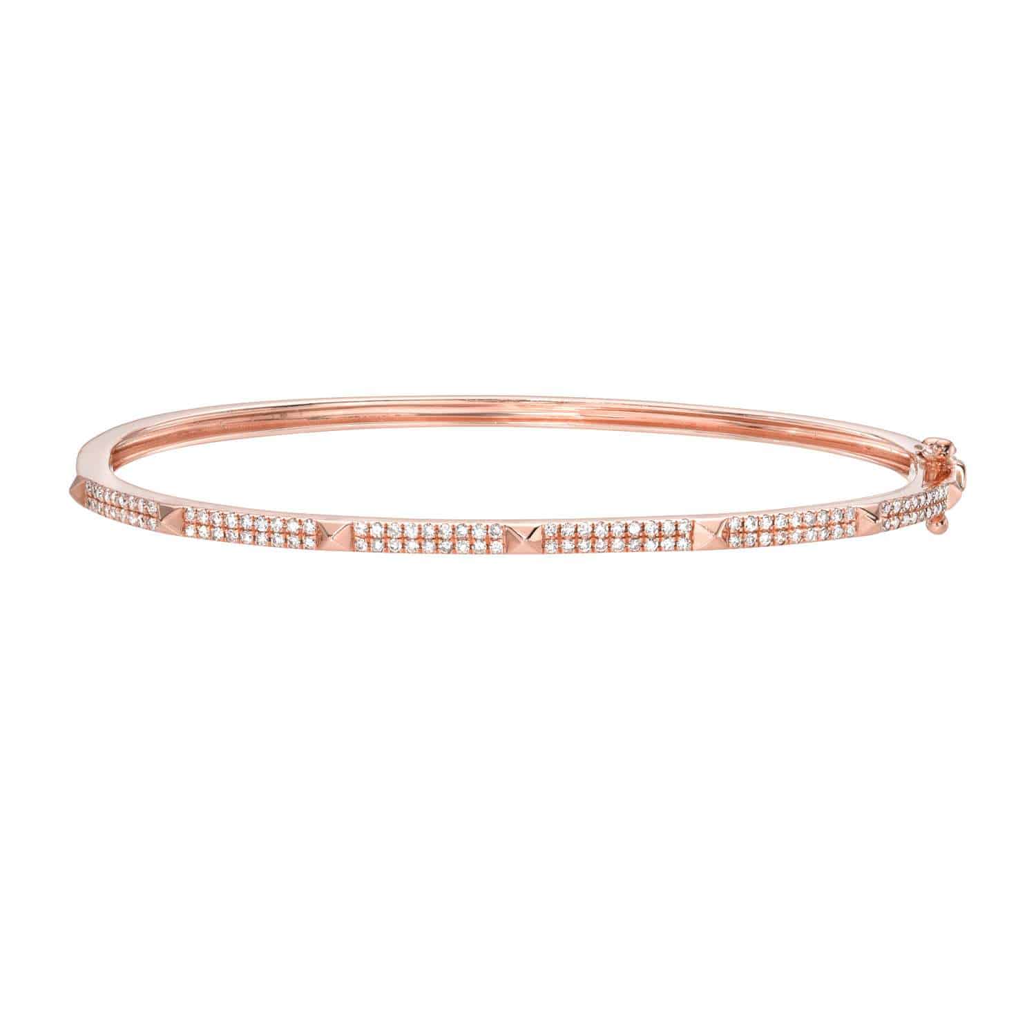 The Diamond Pyramid Olivia Bangle is a slim rose gold bracelet featuring two rows of sparkling small diamonds and geometric pyramid stud accents, displayed against a white background.