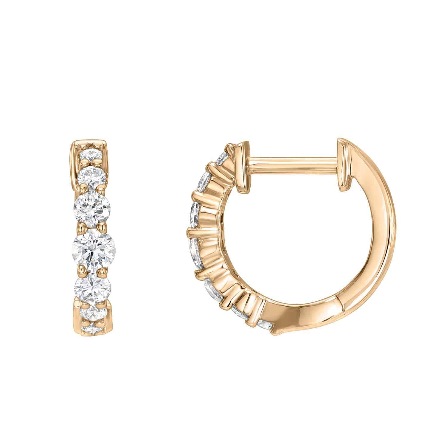 Graduating Diamond Huggies featuring three round, clear diamonds arranged vertically on the front of each gold hoop. One earring is displayed from the front to highlight the graduating gemstones, while the other showcases the side and clasp mechanism. A timeless piece from Janet Heller Fine Jewelry, these huggies exemplify fine craftsmanship and elegant design.
