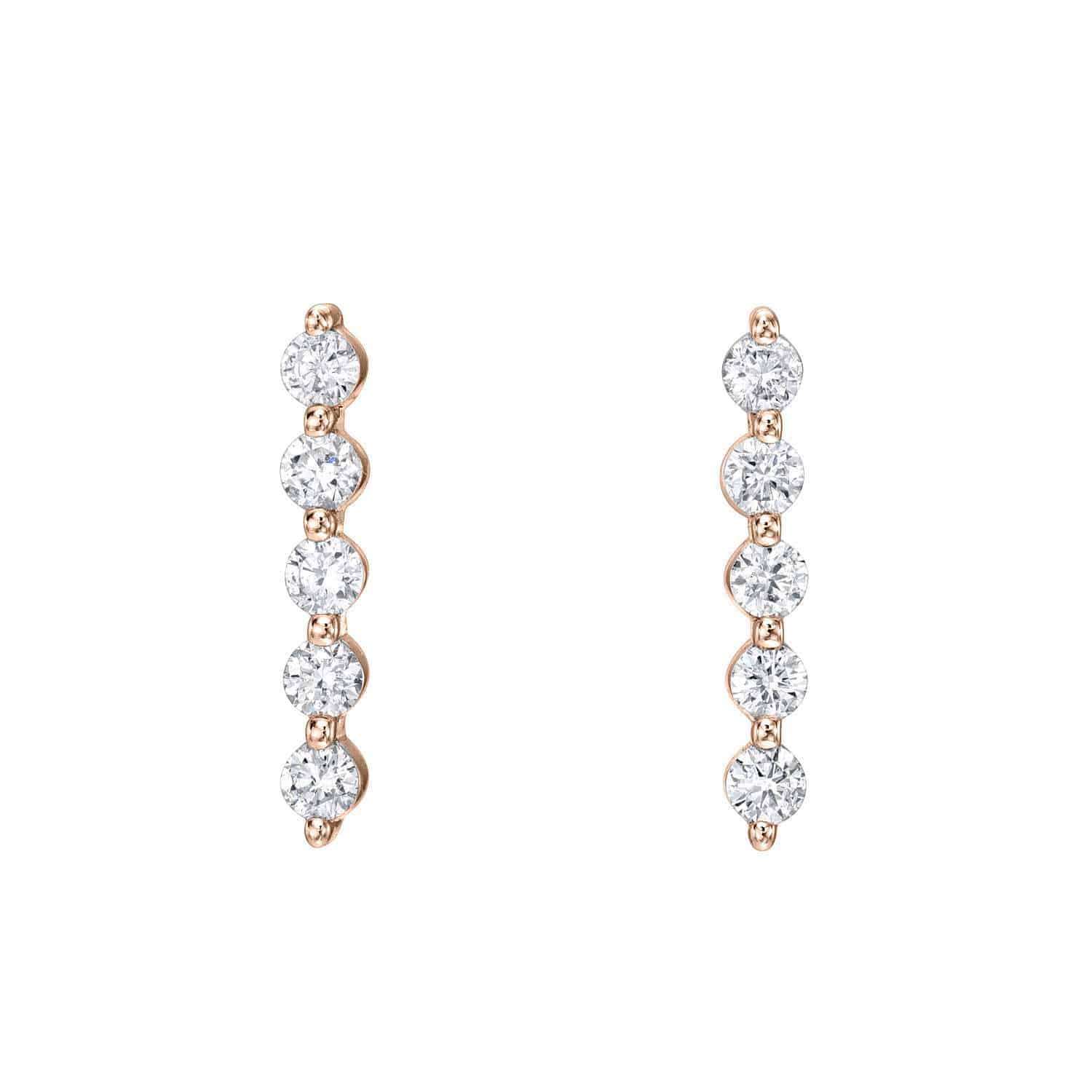Introducing the Long Diamond Bar Studs from Janet Heller Fine Jewelry—vertical gold earrings adorned with five round white diamonds set in a straight line. For custom jewelry or inquiries, please contact us.
