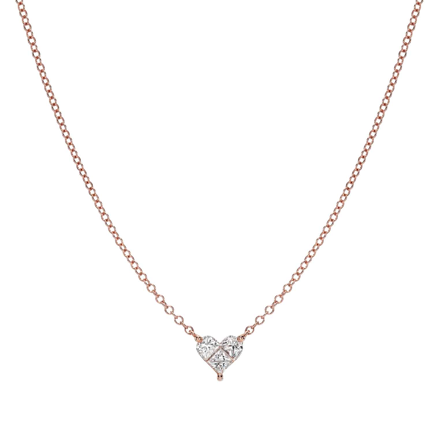 The Solitaire Heart Cut Diamond Necklace features a delicate rose gold chain and a small, heart-shaped diamond pendant at its center, beautifully reflecting the elegance and craftsmanship of Janet Heller Fine Jewelry.
