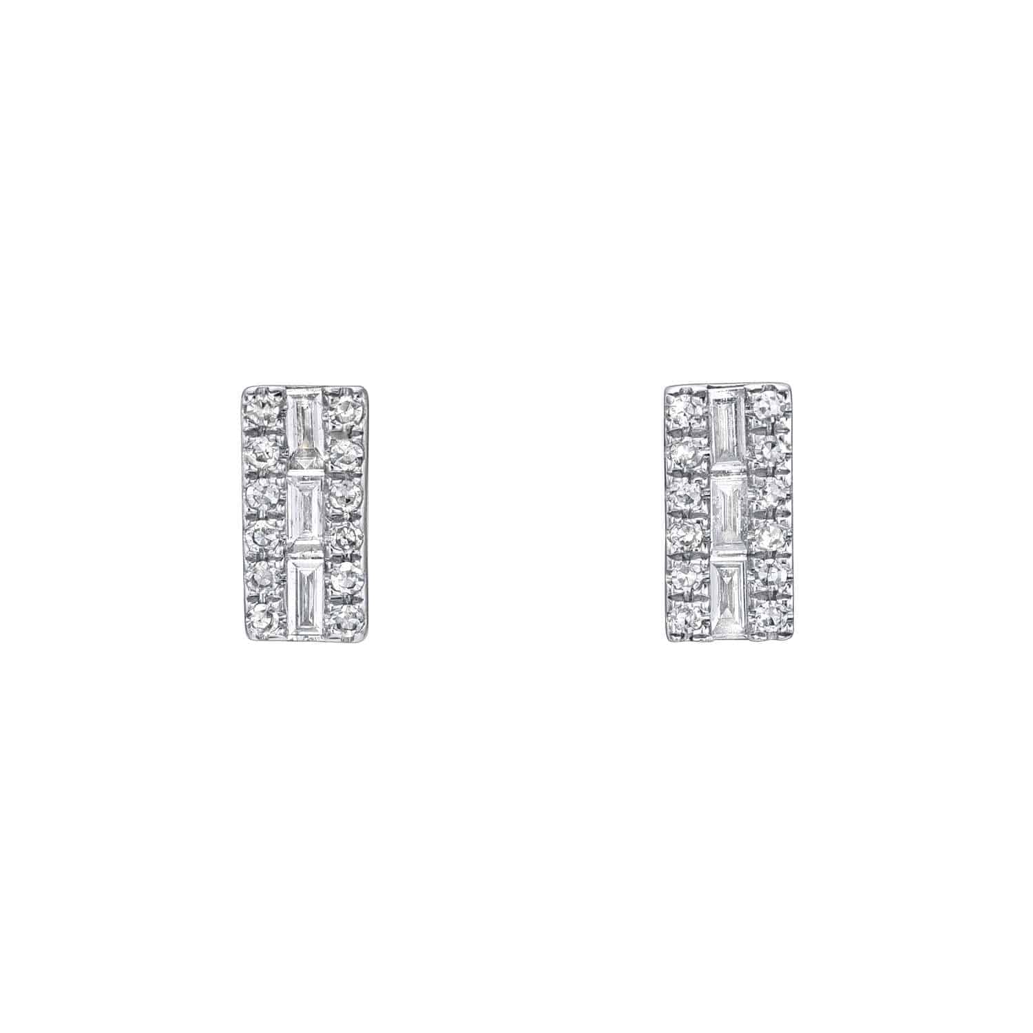 The Baguette Diamond Rectangle Studs from Janet Heller Fine Jewelry are crafted in 14KT gold.  They feature rows of small round diamonds around a central emerald-cut diamond. The studs can be worn alone or layered along the ear with other earrings.