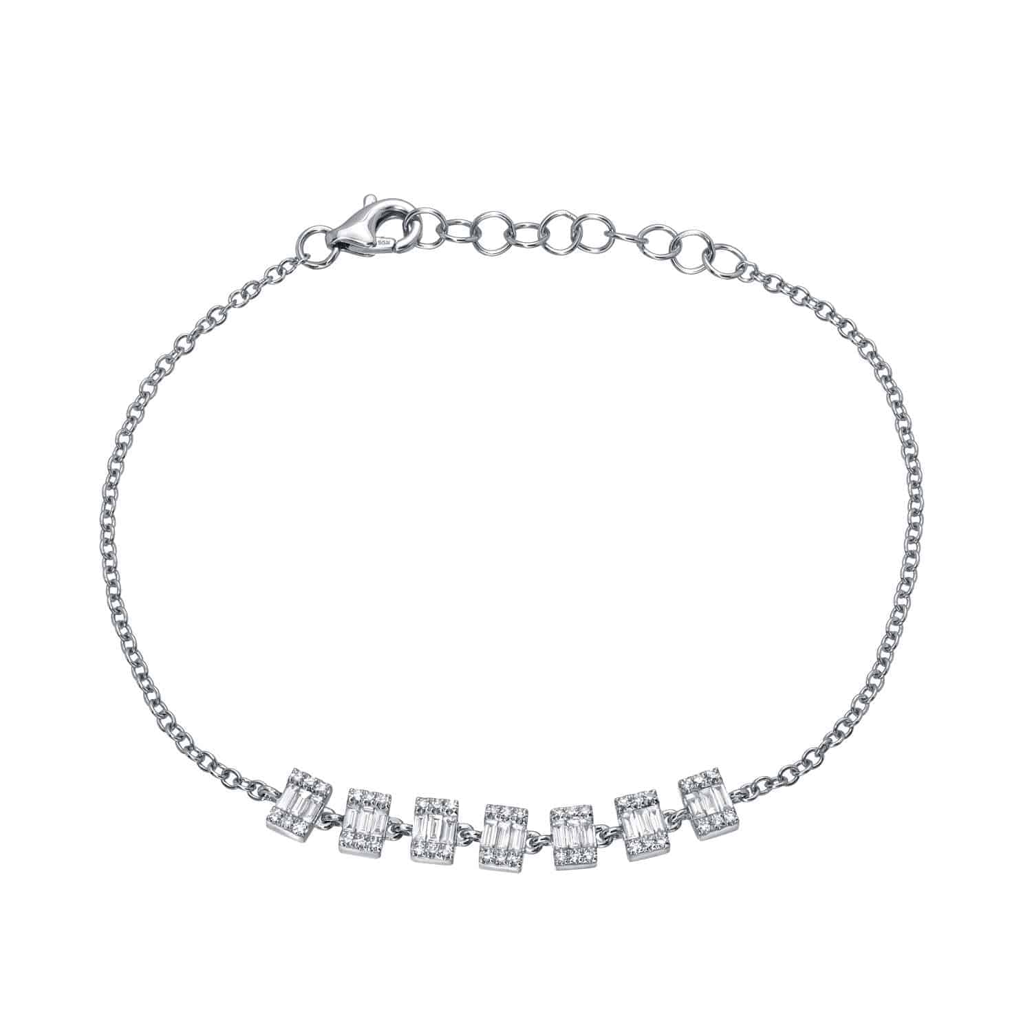 Discover the exquisite craftsmanship of Janet Heller Fine Jewelry with the Baguette Diamond Rectangles Bracelet—a silver chain bracelet featuring seven rectangular segments elegantly set with small, sparkling clear baguette diamonds arranged in a row at the center and secured with a lobster clasp. For custom jewelry or inquiries, explore this stunning piece and more from Janet Heller Fine Jewelry.