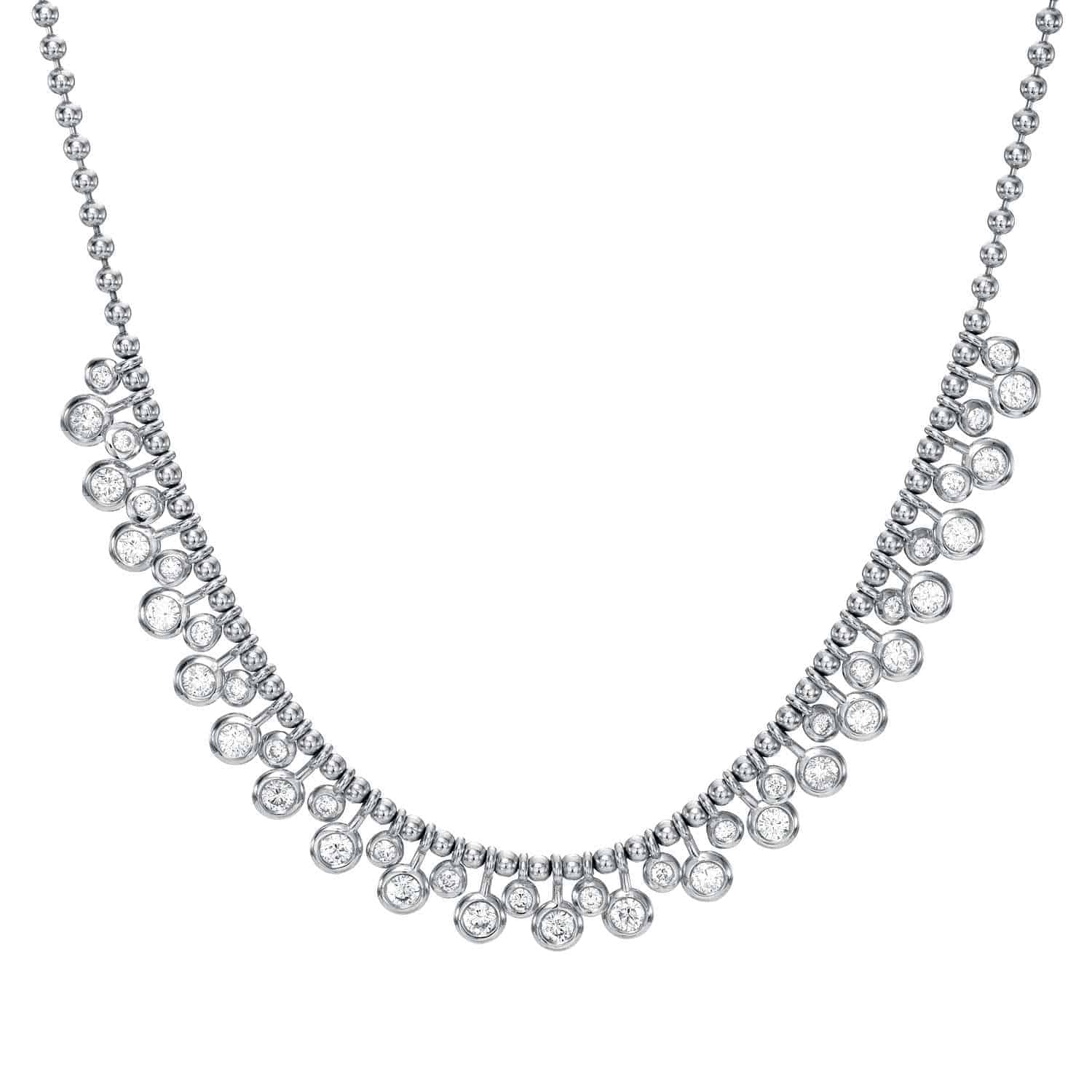 A stunning piece from Janet Heller Fine Jewelry, the Diamond Dangle Toilet Chain Necklace features a beaded silver chain adorned with multiple round, clear gemstones arranged in a graduated, cascading pattern along the front—expertly showcasing both custom artistry and the enduring allure of fine jewelry.