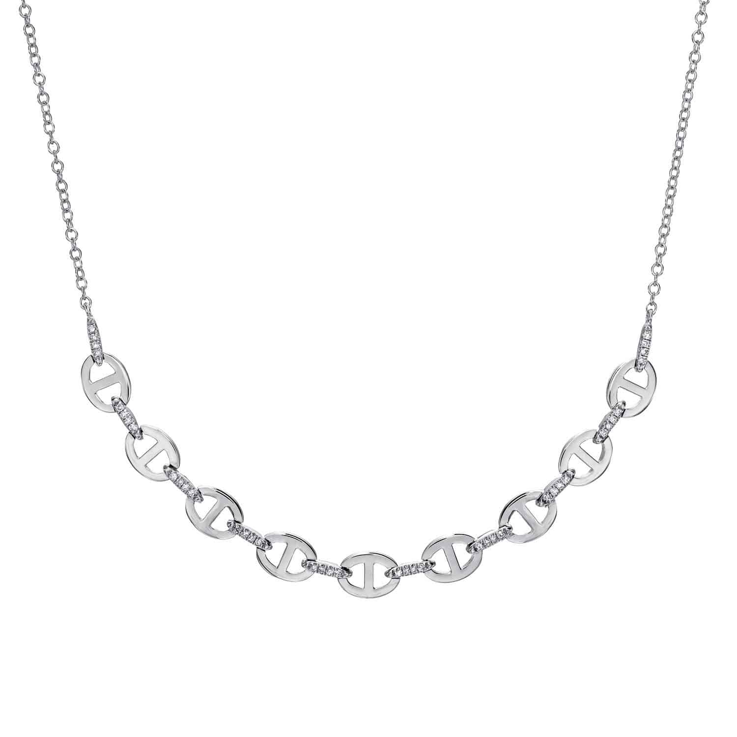 Diamond Kaia Necklace from Janet Heller Fine Jewelry features a delicate silver chain with interlocking oval links, each showcasing a cutout G-shaped design and accented with small sparkling stones between the links. For jewelry inquiries or to explore custom options, please contact us directly.
