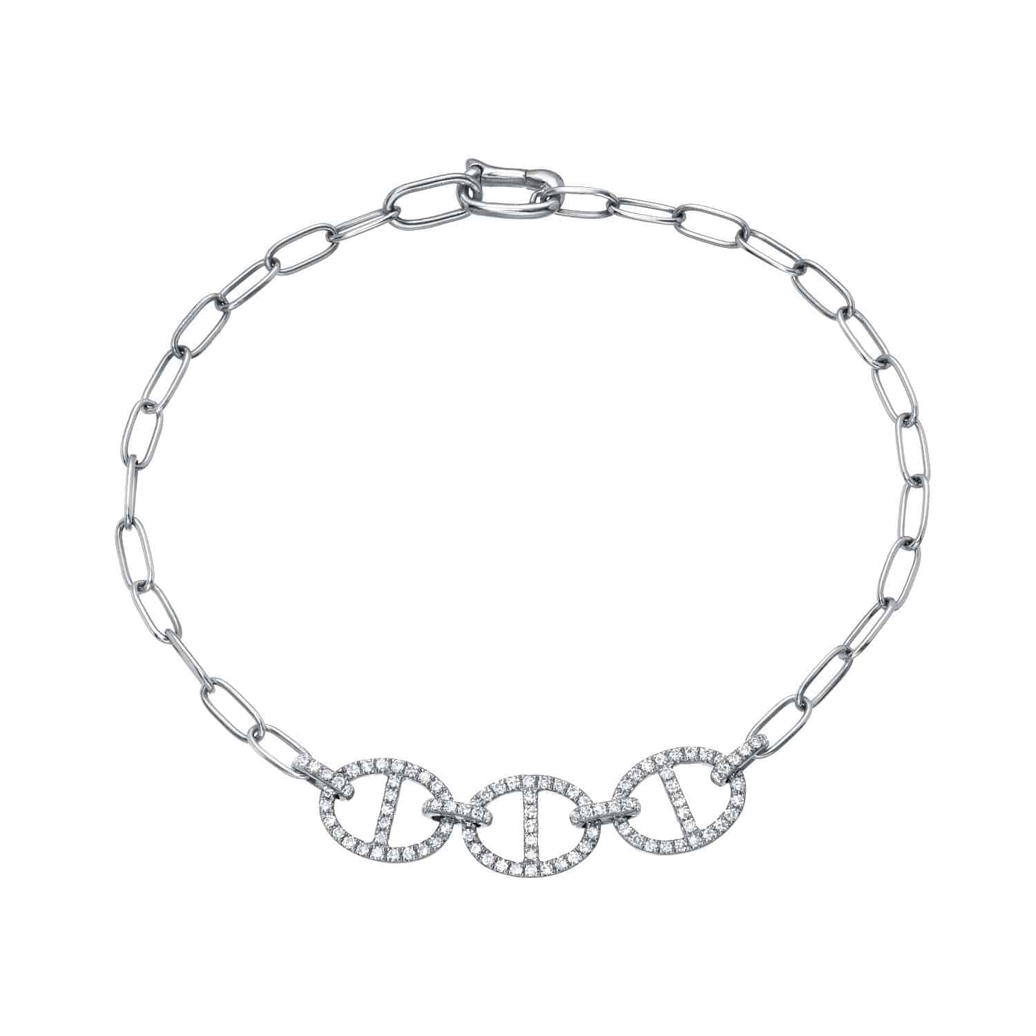 Diamond Presley Bracelet—an elegant creation by Janet Heller Fine Jewelry—features three interconnected oval-shaped links at the center, each encrusted with small, clear gemstones and attached to a silver paperclip-style chain with a matching clasp.