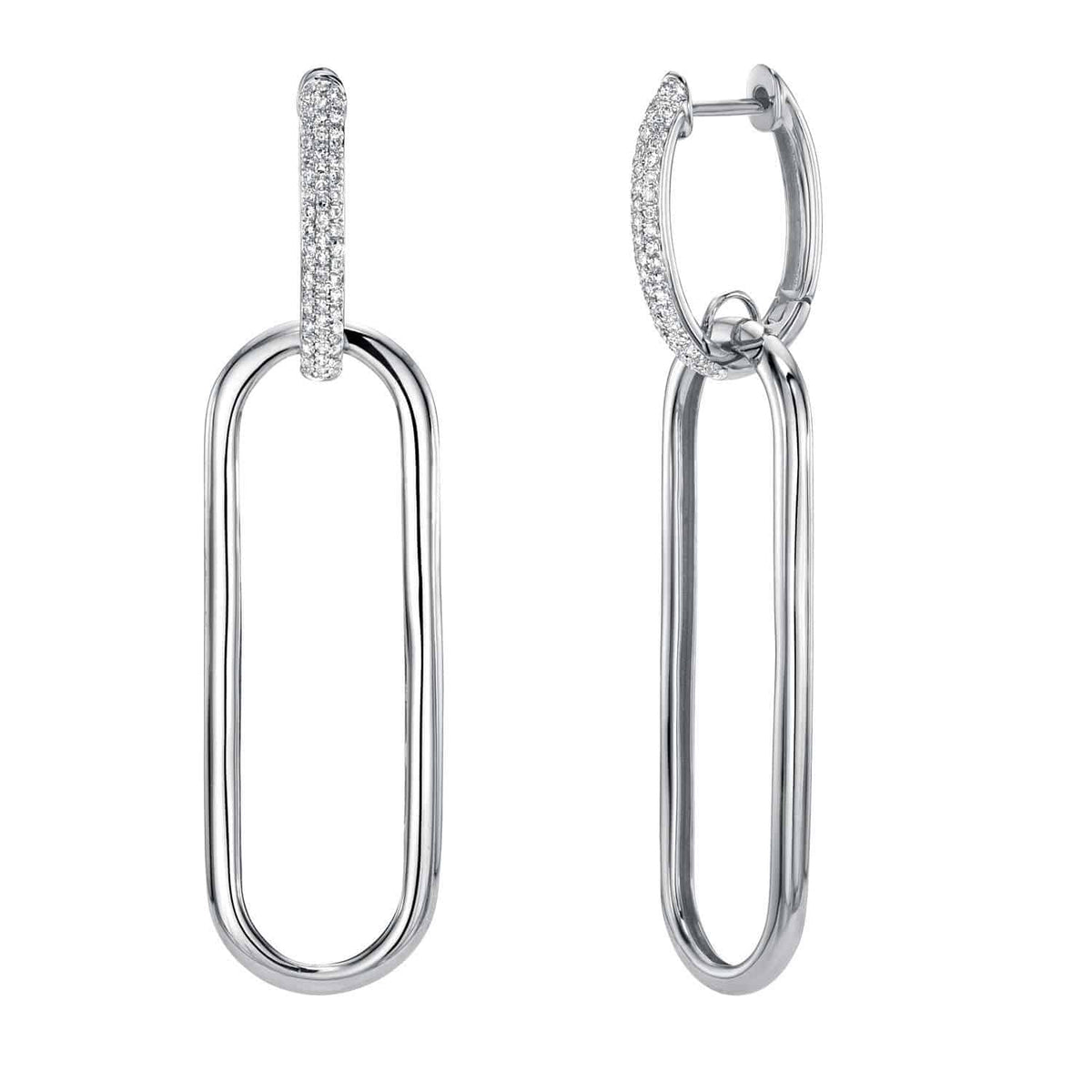 Introducing the Large Diamond Jordan Earrings from Janet Heller Fine Jewelry. These modern and elegant silver drop earrings each feature an elongated oval link, with a small hoop at the top adorned with sparkling clear stones. Expertly crafted as part of our custom jewelry collection, they reflect refined craftsmanship and sophisticated design. For jewelry inquiries or more information about the Large Diamond Jordan Earrings, please contact us.