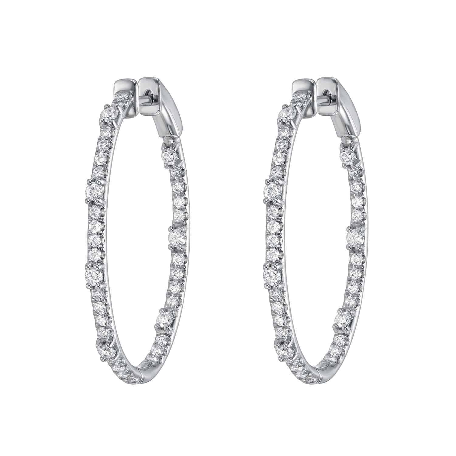 The Oval Chandler Hoops from Janet Heller Fine Jewelry are silver earrings featuring a row of sparkling diamonds along the outer edge. They include a smooth clasp for secure fastening, embodying timeless elegance in fine jewelry.