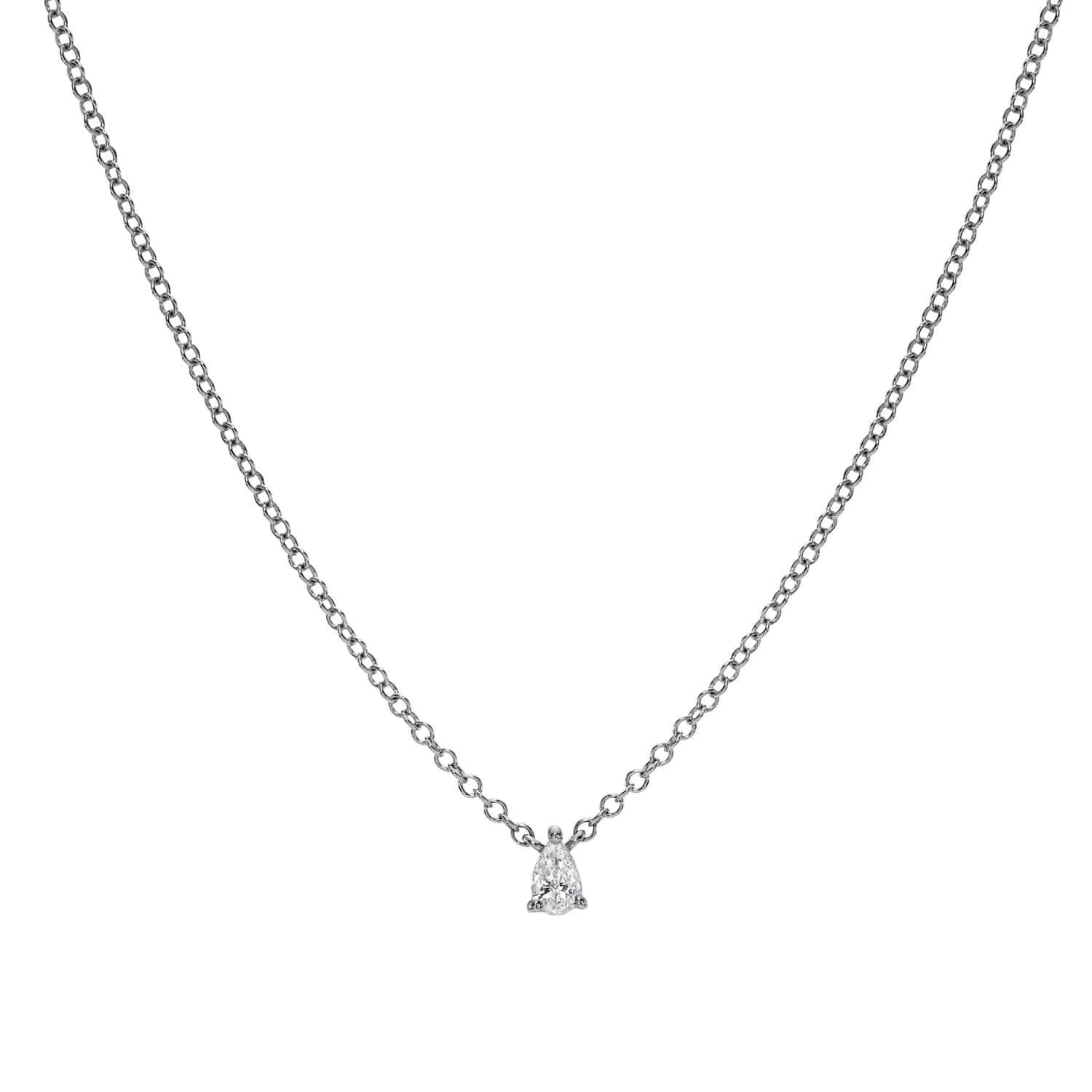 A delicate silver chain necklace featuring a petite, pear-cut solitaire diamond pendant at the center, displayed on a white background. This timeless Solitaire Pear Cut Diamond Necklace from Janet Heller Fine Jewelry is perfect for those seeking custom jewelry or with specific jewelry inquiries.