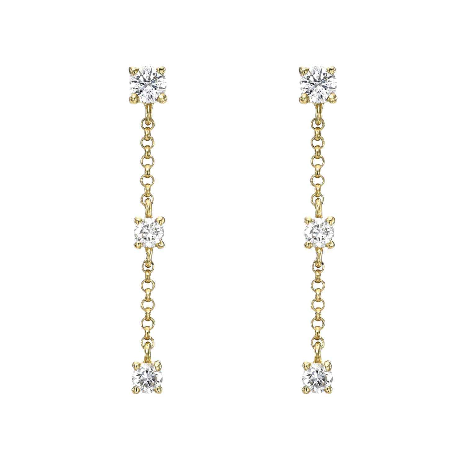 The 3 Drop Diamond Finley Earrings by Janet Heller Fine Jewelry are crafted in 14KT gold. The dangling earrings feature three evenly spaced round diamonds connected by a delicate chain. The earrings can be worn alone or layered along the ear with other earrings.