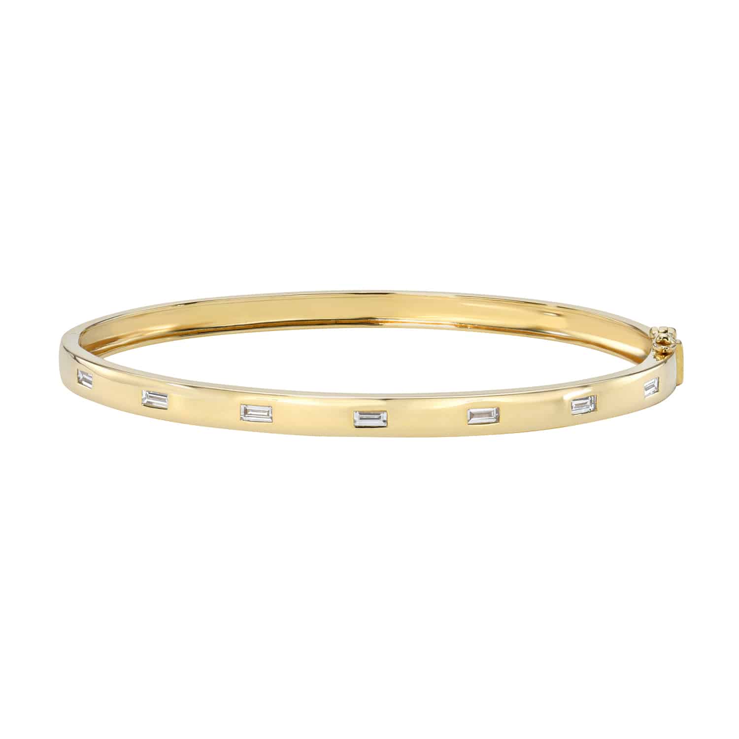 The Baguette Diamond Bangle from Janet Heller Fine Jewelry is crafted in 14KT gold and is embellished with seven baguette diamonds. The bangle can be worn on its own or stacked with other bracelets.