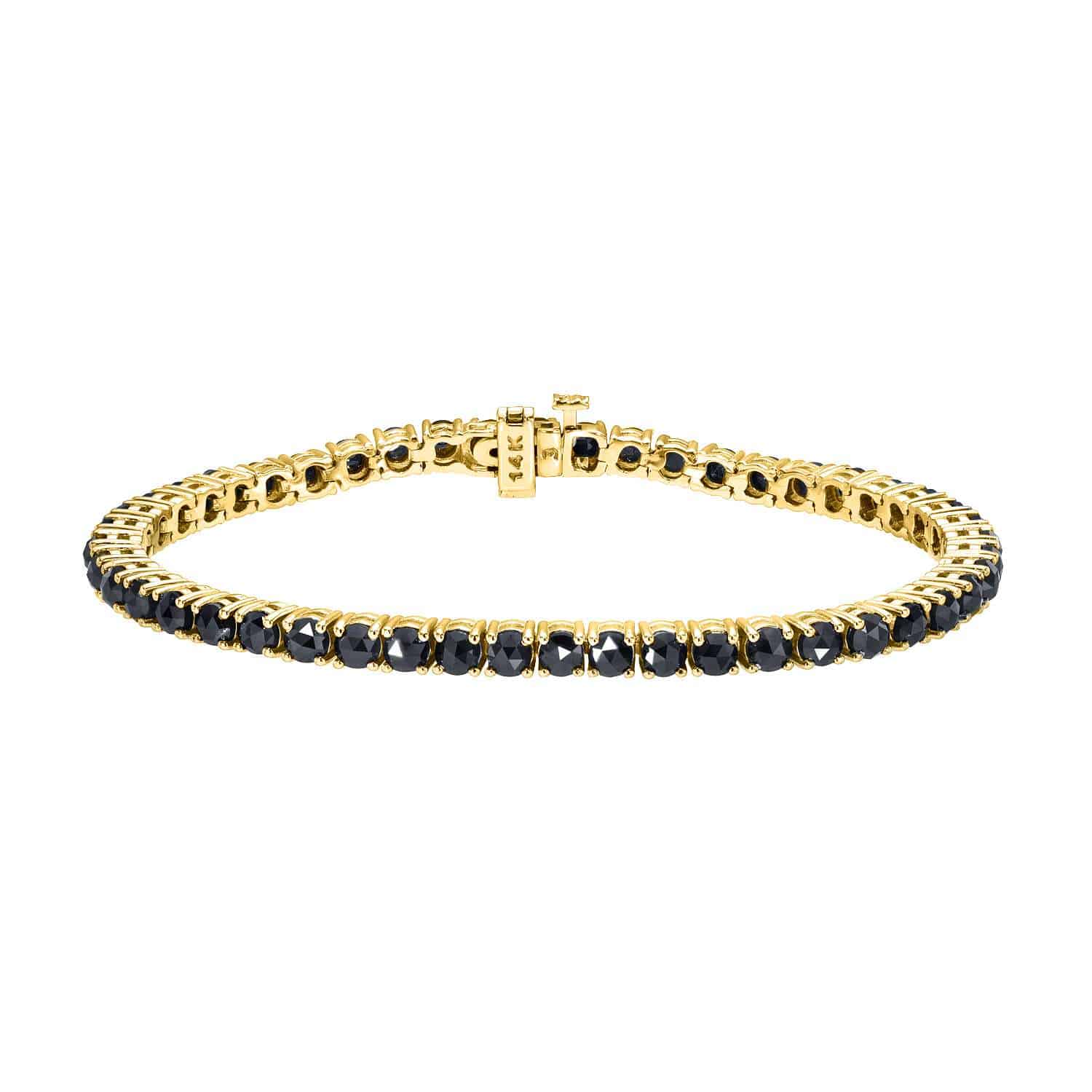 Introducing the Black Diamond Tennis Bracelet (BRA-174-Y) from Janet Heller Fine Jewelry—a stunning gold bracelet adorned with a continuous row of round black diamonds and finished with a secure clasp, embodying exceptional elegance at $5,565.