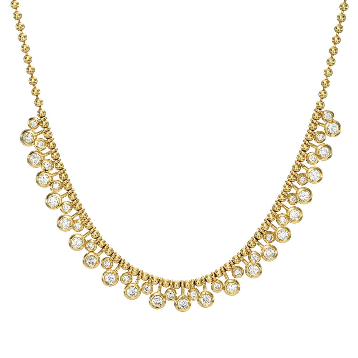 The Diamond Dangle Toilet Chain Necklace by Janet Heller Fine Jewelry is an elegant gold piece with round, clear gemstones spaced evenly along the chain, featuring smaller beads and larger gems in a scalloped design. Contact us for product inquiries or customizations.