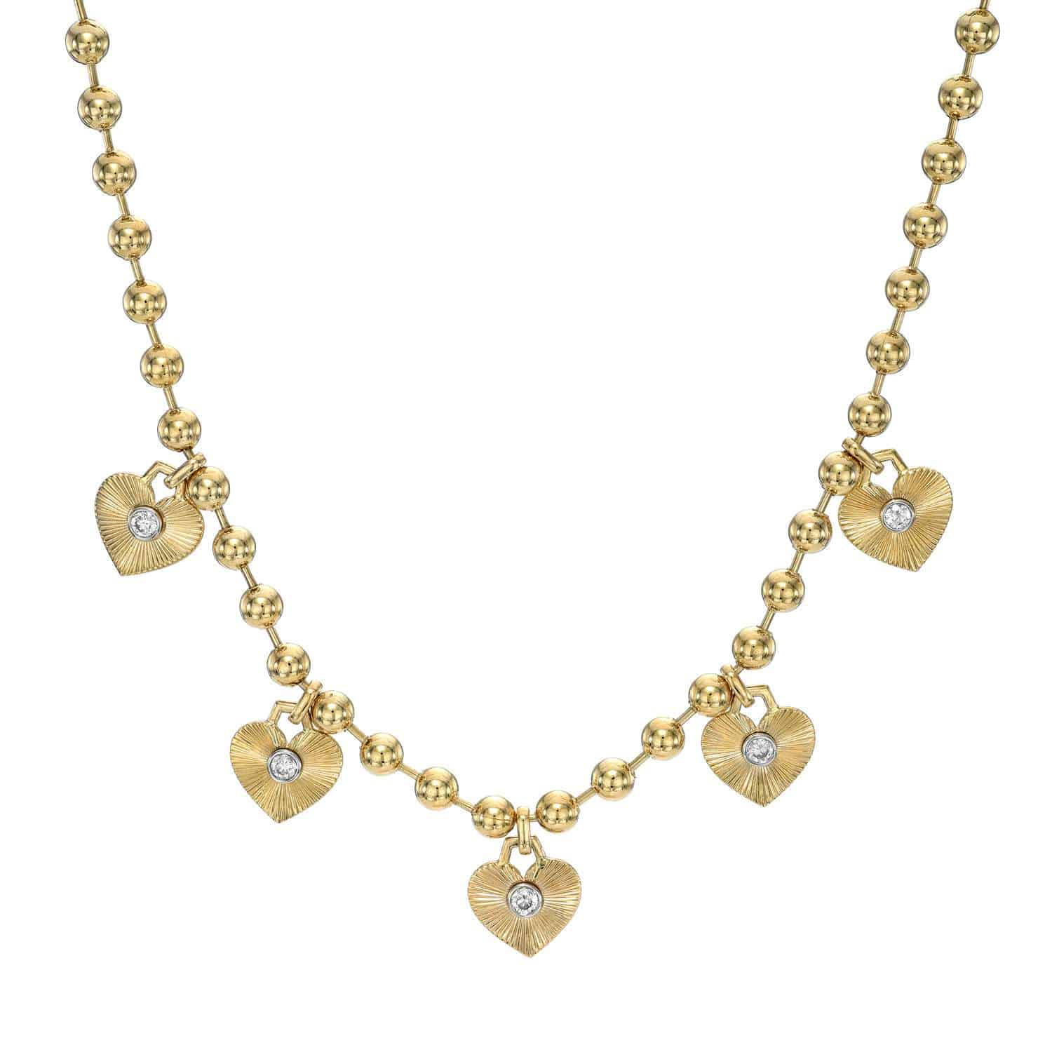 Introducing the Diamond Heart Scarlett Necklace: a stunning gold piece adorned with small beads and five heart-shaped pendants. Each pendant boasts elegant textures and a sparkling diamond-like stone at its center, allowing endless customizations to match your style.